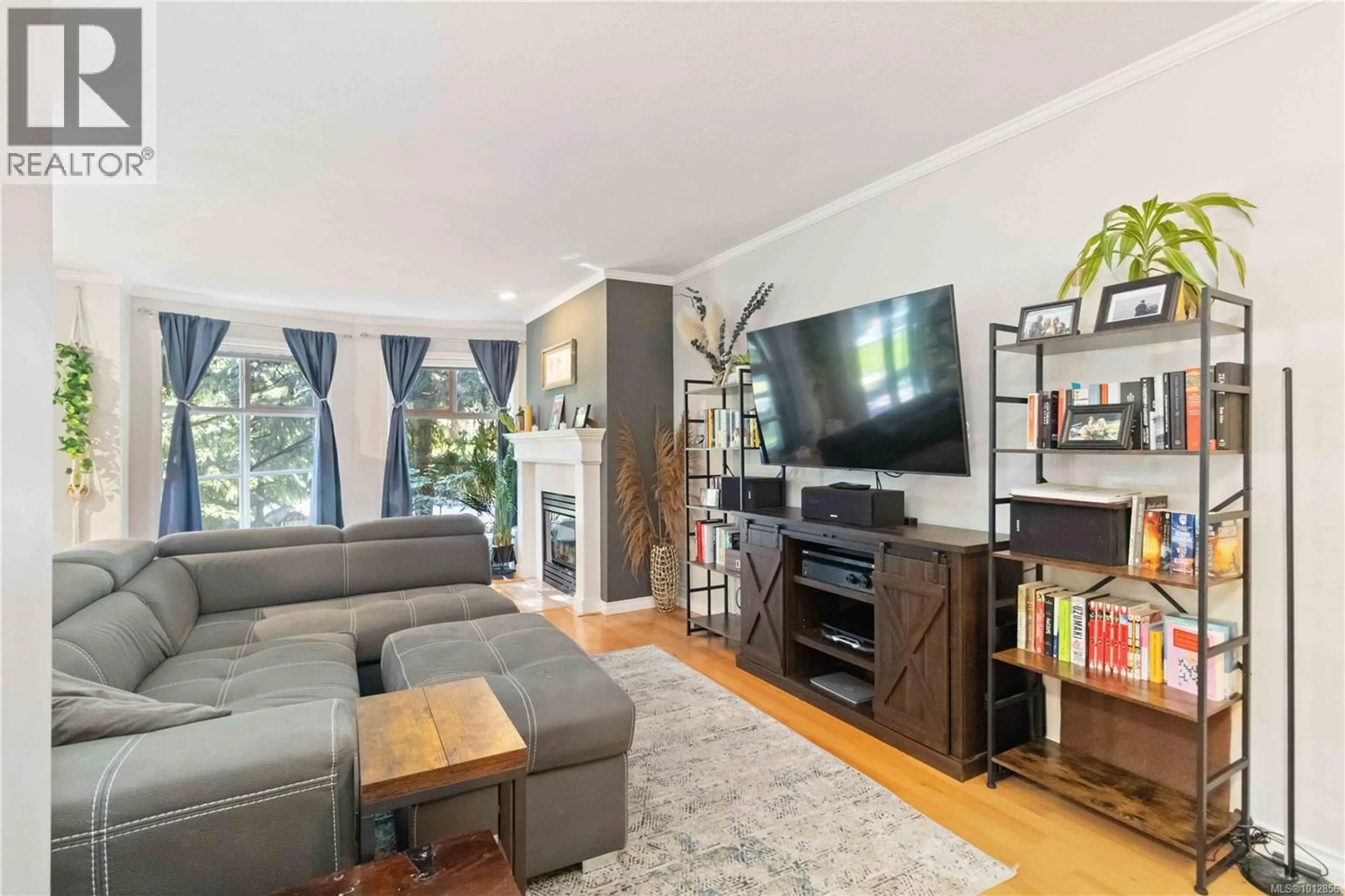 Living room with furniture, wood/laminate floor for 206 - 898 VERNON AVENUE, Saanich British Columbia V8X2W6