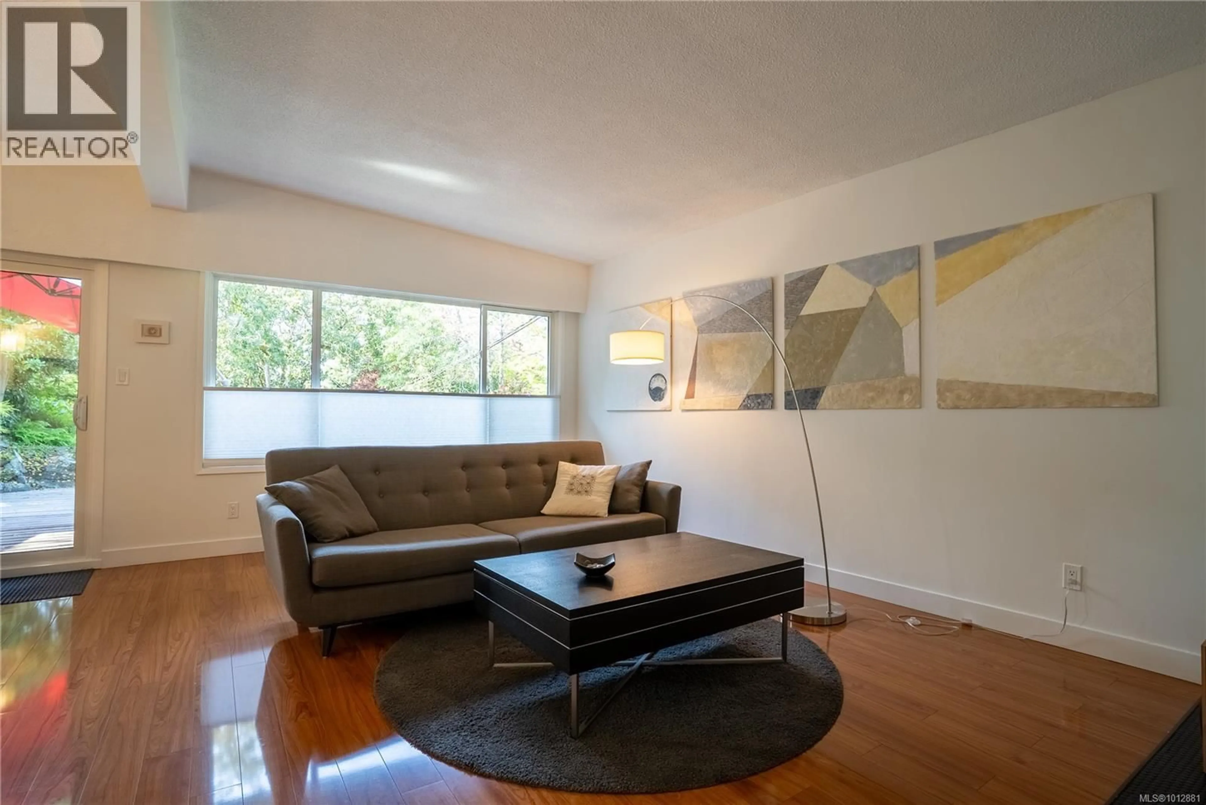 Living room with furniture, wood/laminate floor for 1376 CRAIGFLOWER ROAD, Esquimalt British Columbia V9A2Y7