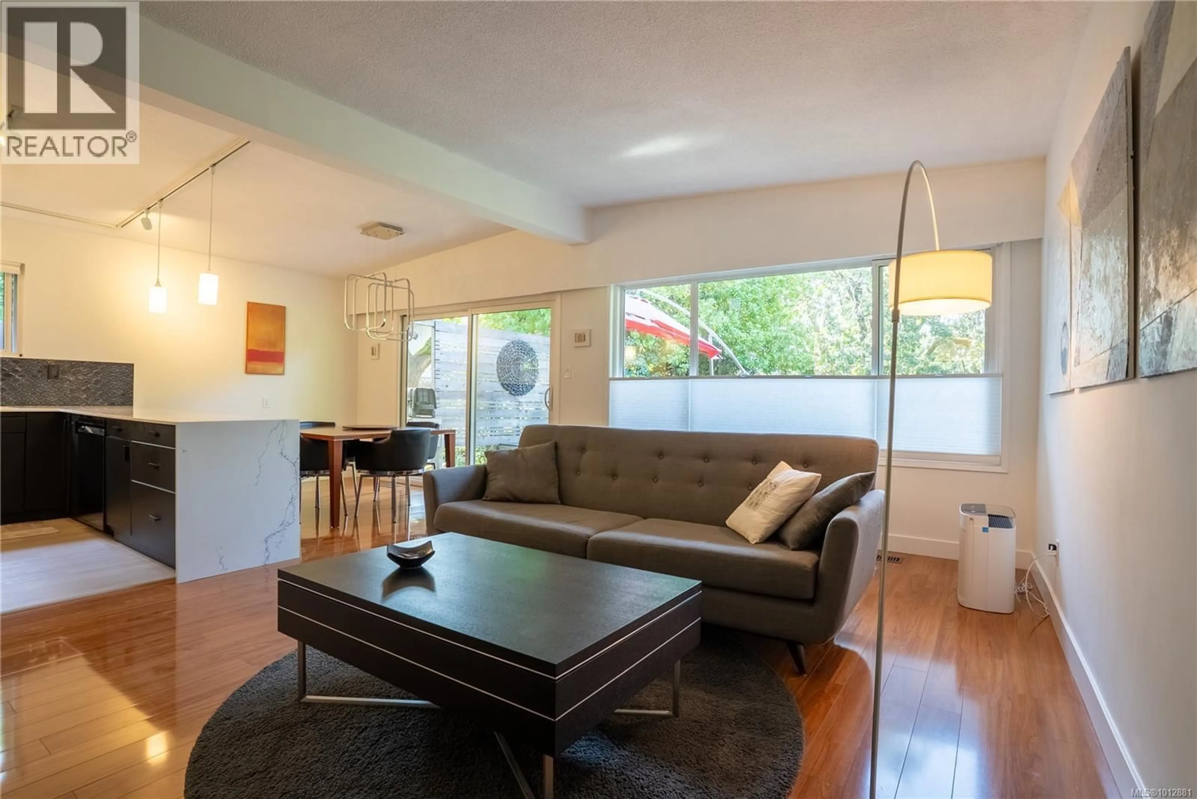 Living room with furniture, wood/laminate floor for 1376 CRAIGFLOWER ROAD, Esquimalt British Columbia V9A2Y7