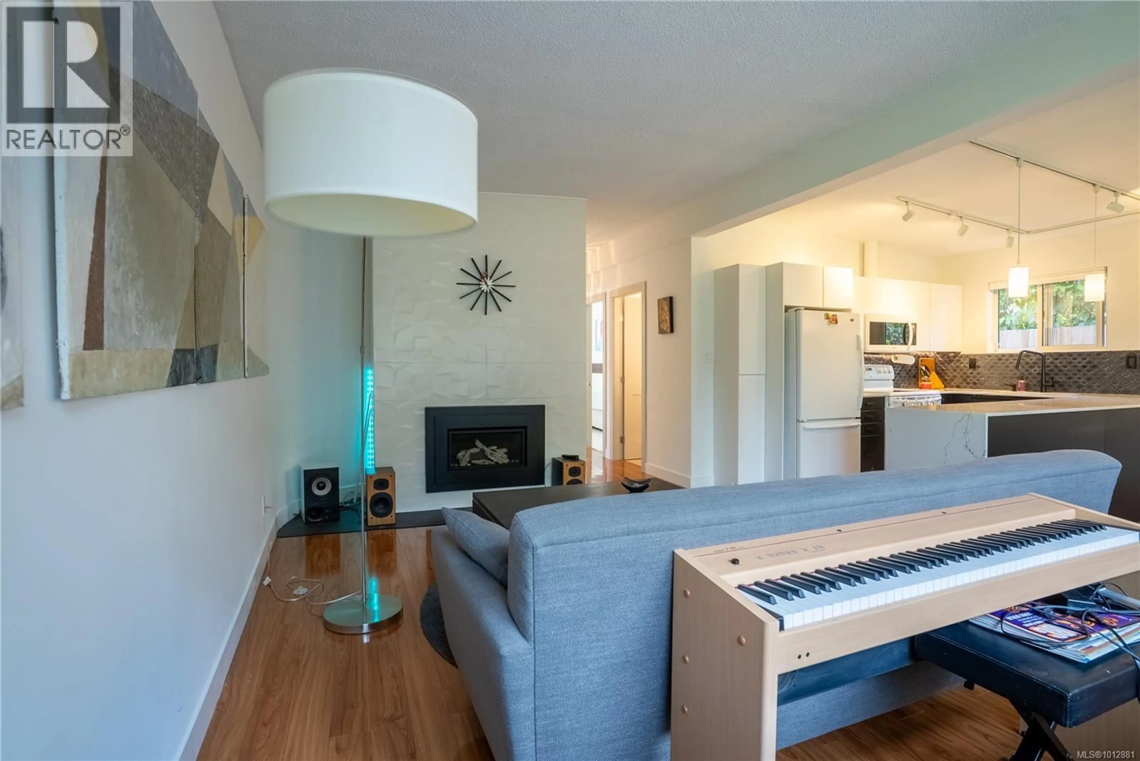 Living room with furniture, wood/laminate floor for 1376 CRAIGFLOWER ROAD, Esquimalt British Columbia V9A2Y7