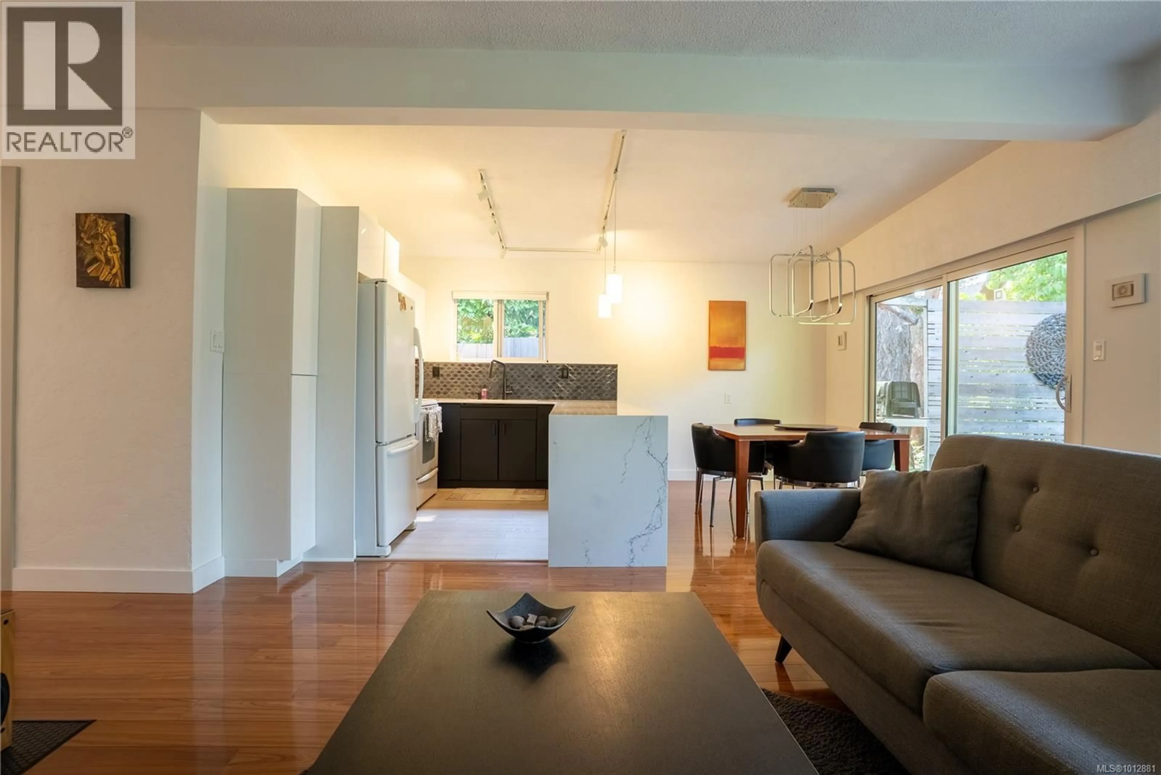 Living room with furniture, wood/laminate floor for 1376 CRAIGFLOWER ROAD, Esquimalt British Columbia V9A2Y7