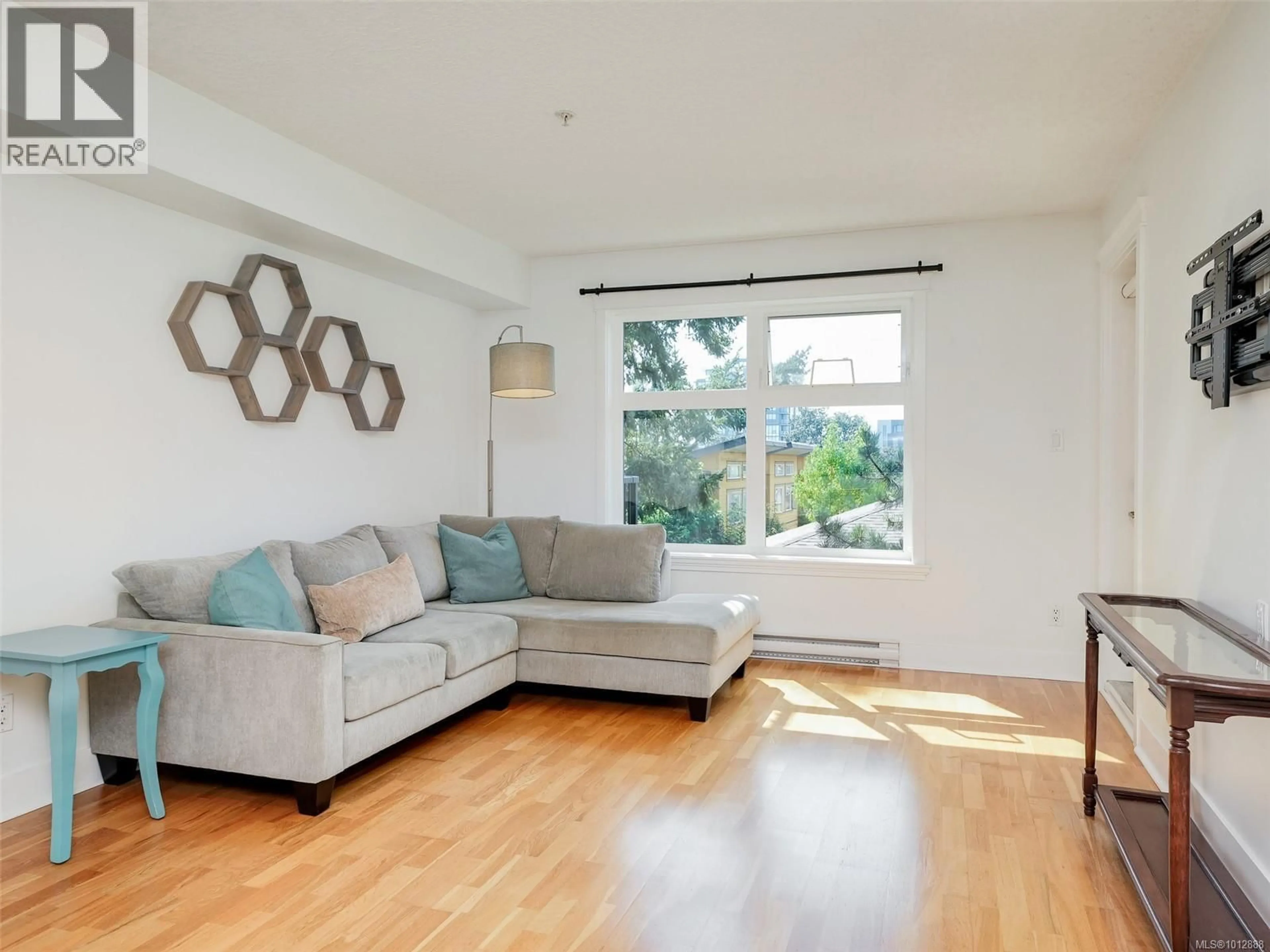 Living room with furniture, wood/laminate floor for 305 - 2717 PEATT ROAD, Langford British Columbia V9B3V2