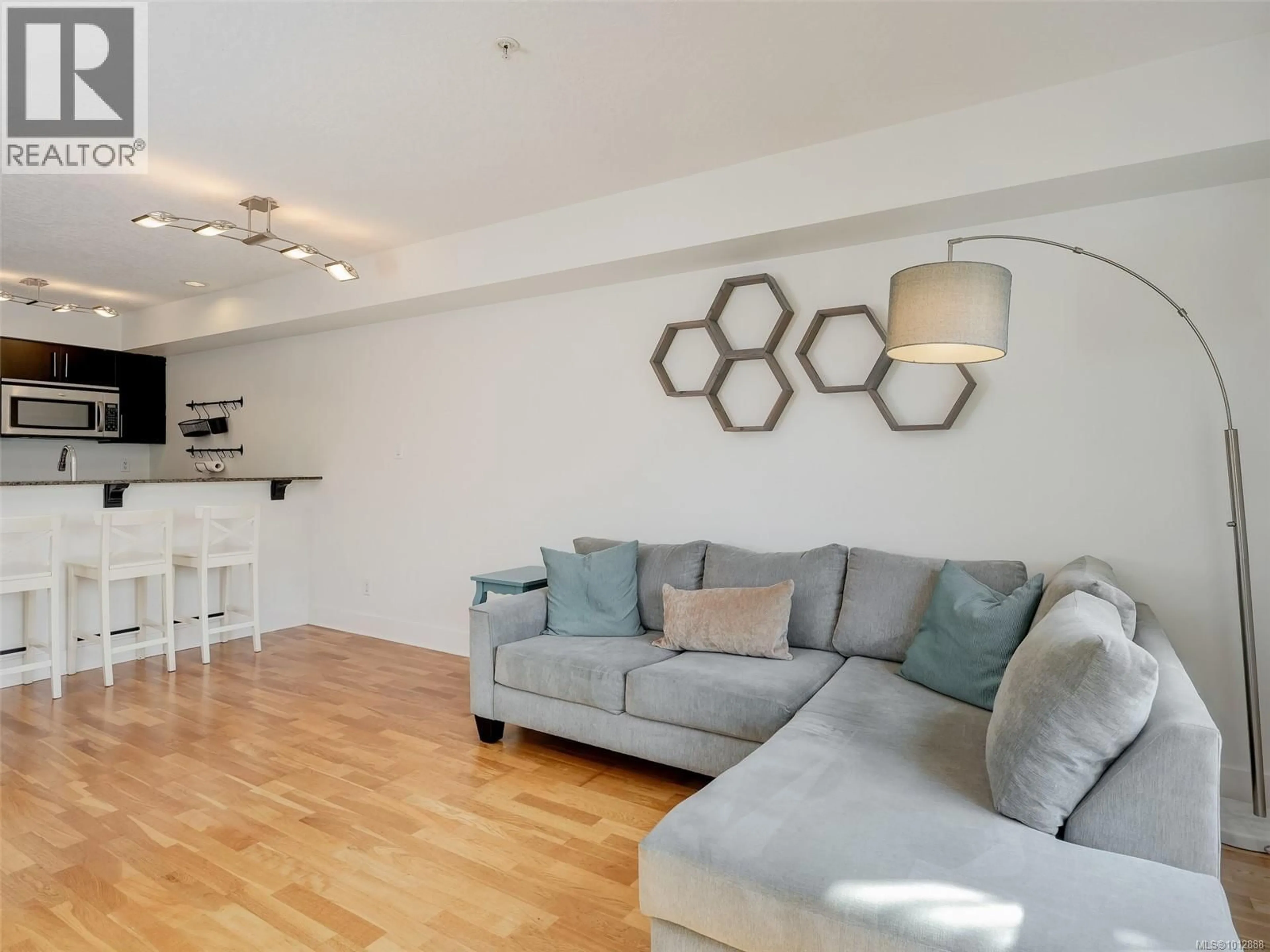 Living room with furniture, wood/laminate floor for 305 - 2717 PEATT ROAD, Langford British Columbia V9B3V2
