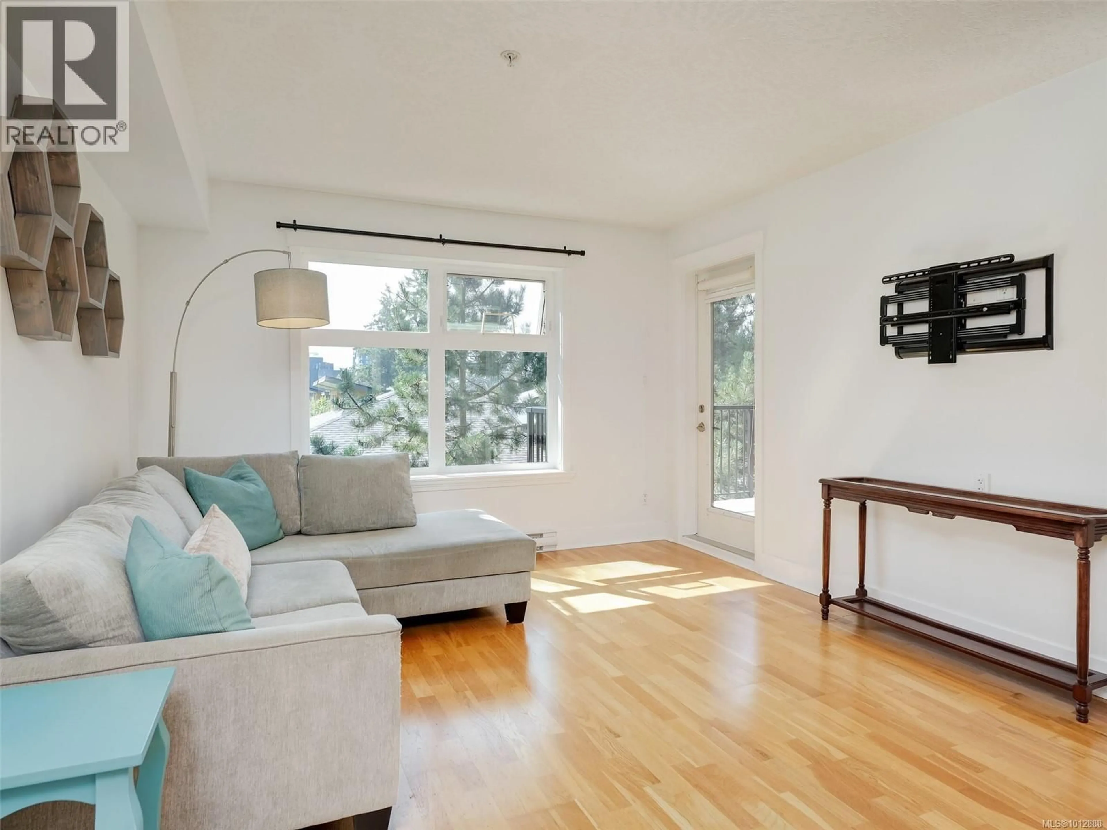 Living room with furniture, wood/laminate floor for 305 - 2717 PEATT ROAD, Langford British Columbia V9B3V2