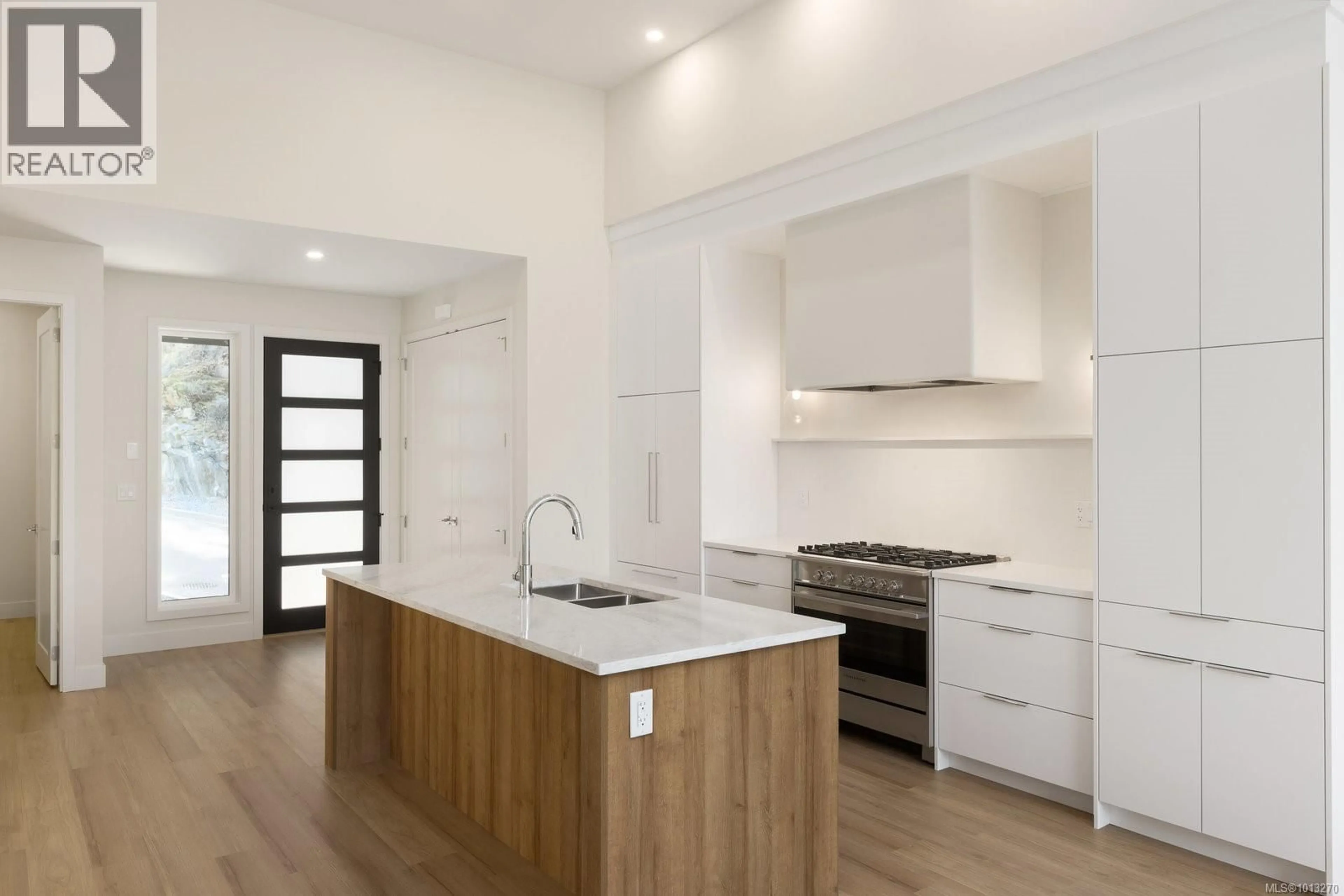 Open concept kitchen, wood/laminate floor for 101 - 2332 COPPER ROCK COURT, Langford British Columbia V9B0G4