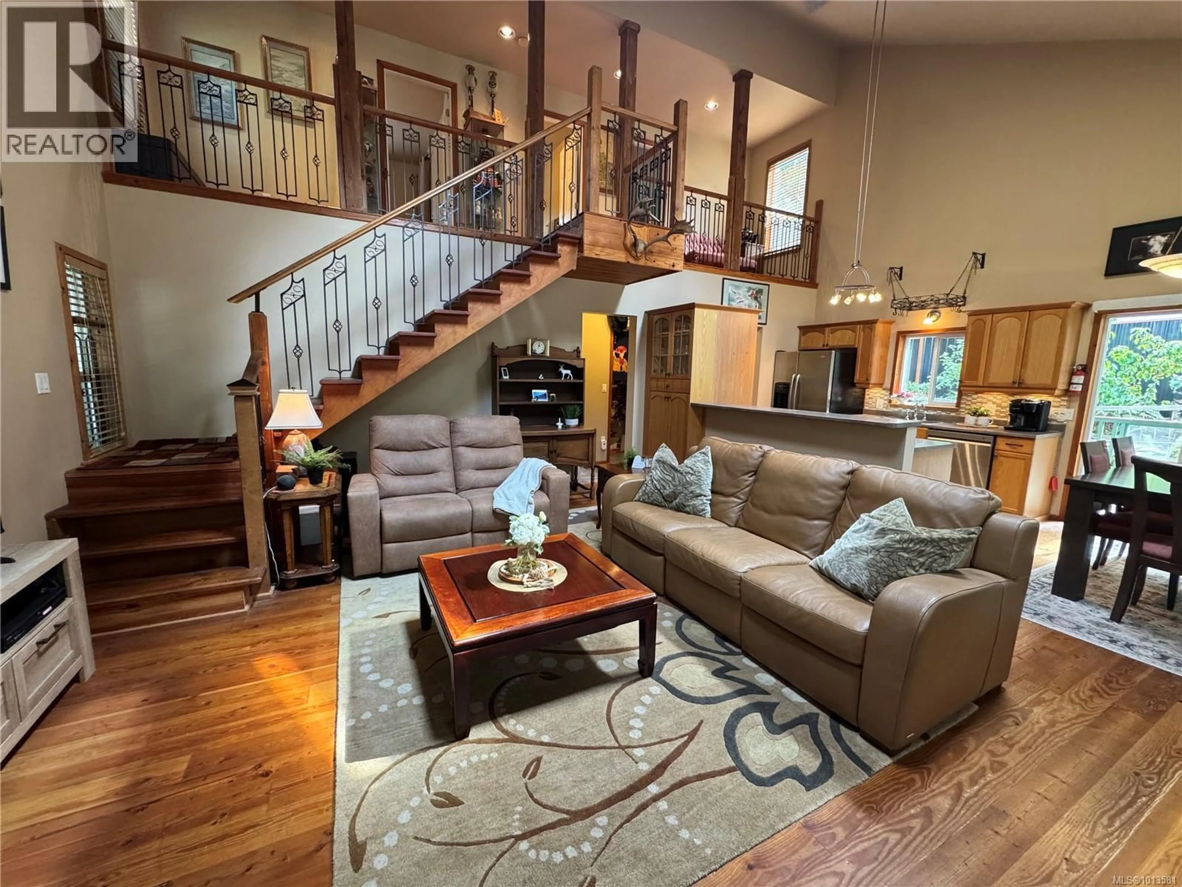 Living room with furniture, wood/laminate floor for 714 CHARTER ROAD, Mayne Island British Columbia V0N2J1