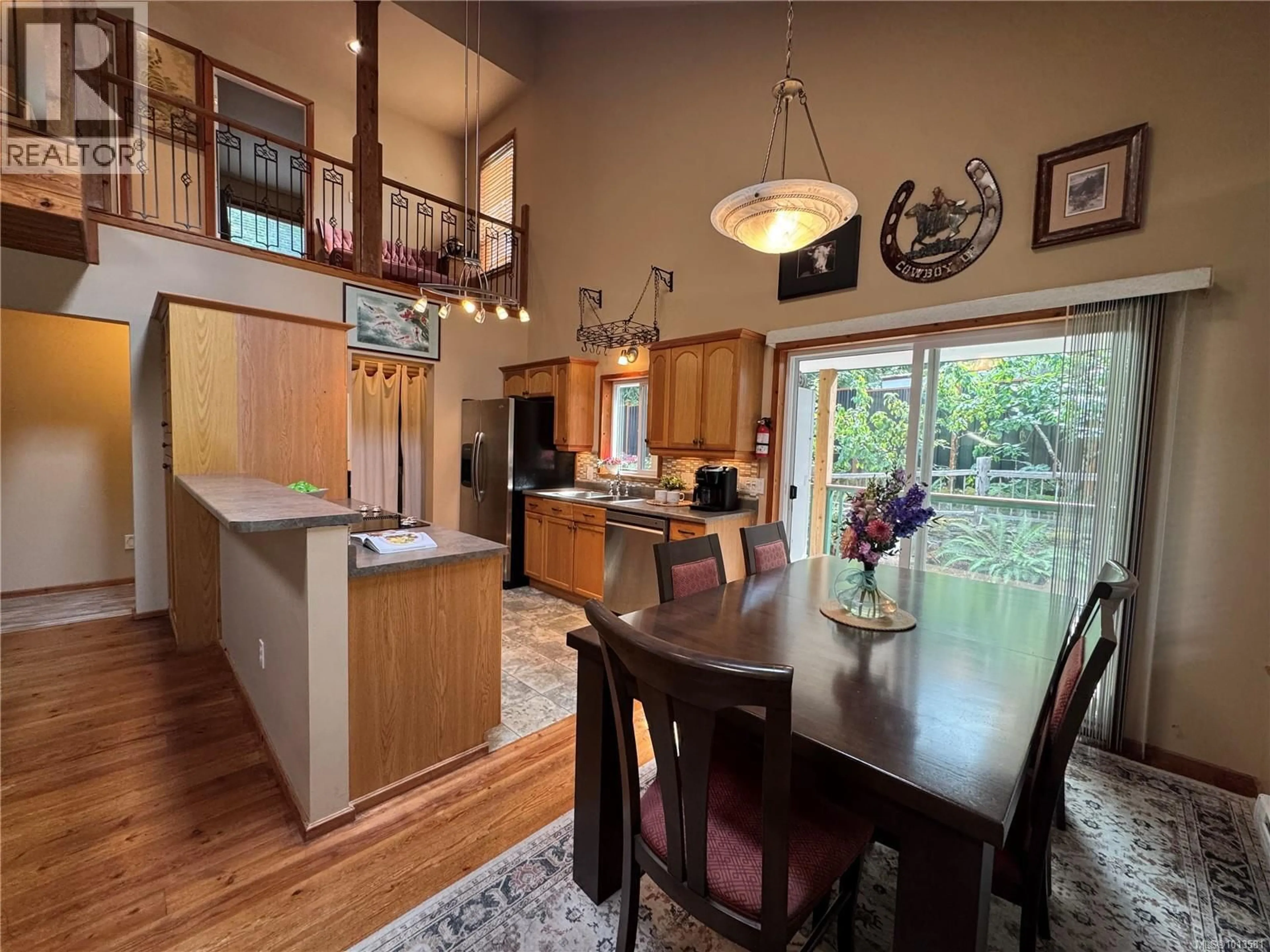 Open concept kitchen, wood/laminate floor for 714 CHARTER ROAD, Mayne Island British Columbia V0N2J1