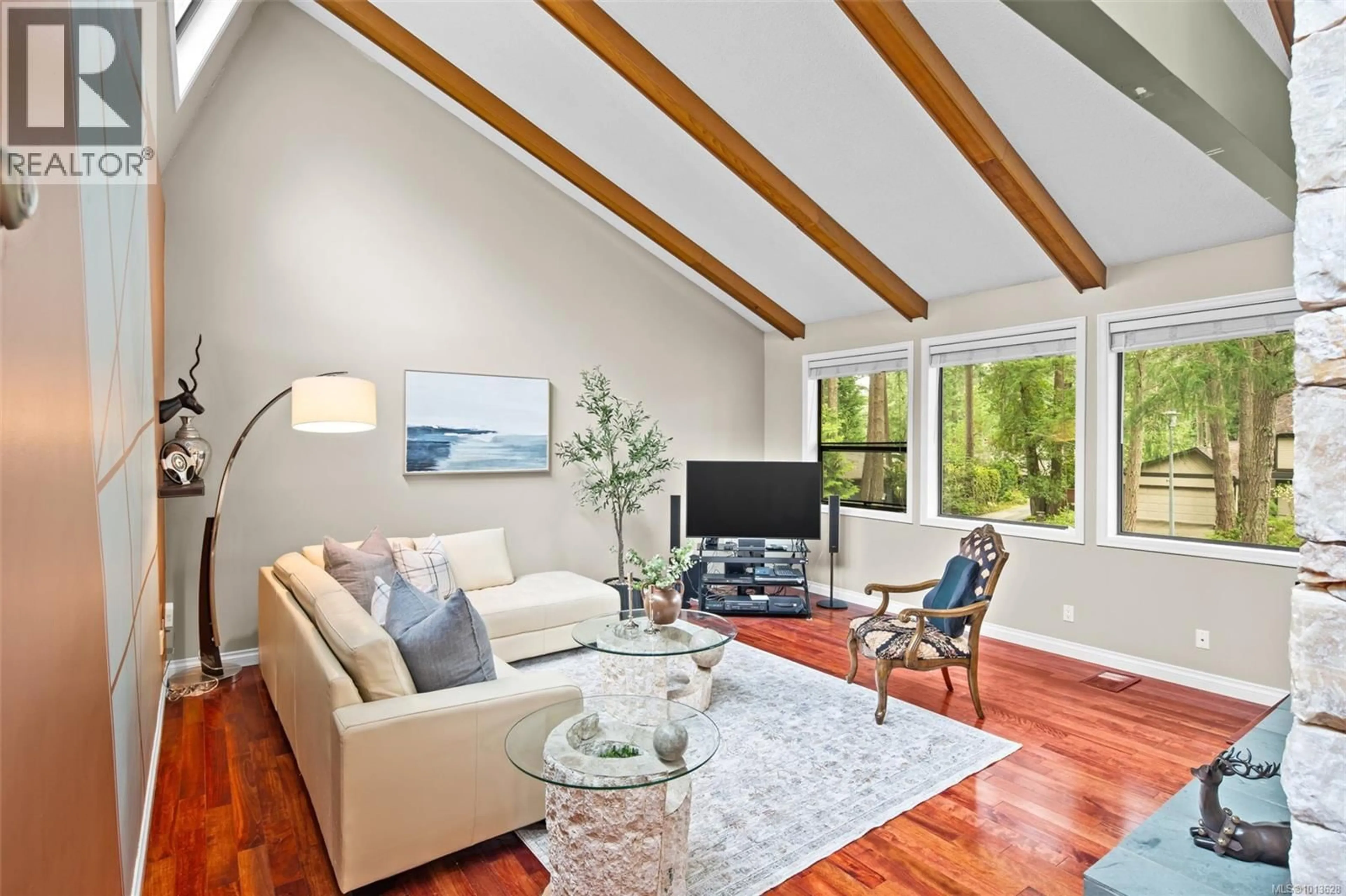 Living room with furniture, wood/laminate floor for 990 COTTONTREE CLOSE, Saanich British Columbia V8X4E9