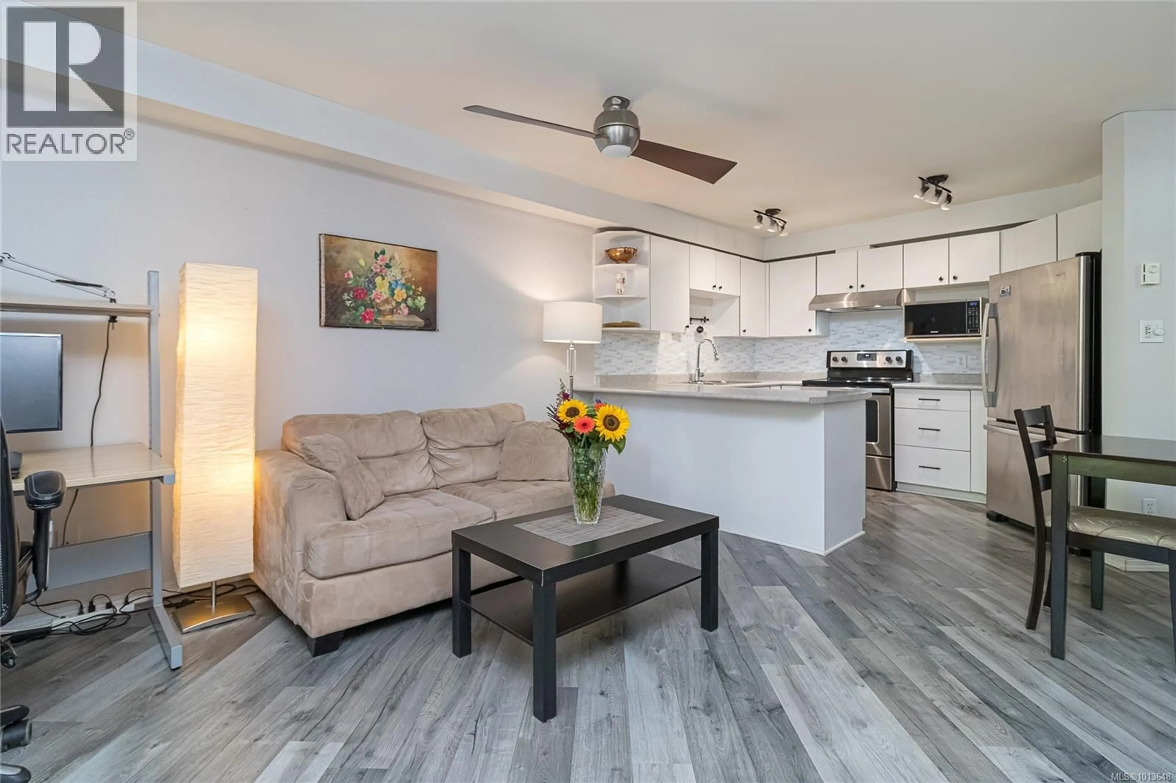 Open concept kitchen, wood/laminate floor for 211 - 494 MARSETT PLACE, Saanich British Columbia V8Z7J1