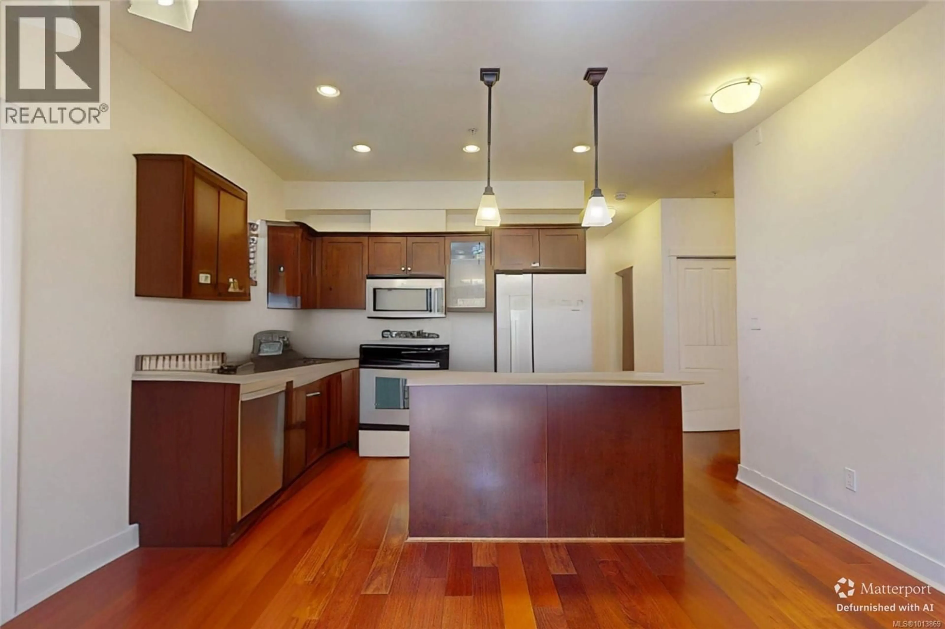 Open concept kitchen, wood/laminate floor for 103 - 201 NURSERY HILL DRIVE, View Royal British Columbia V9B0H7