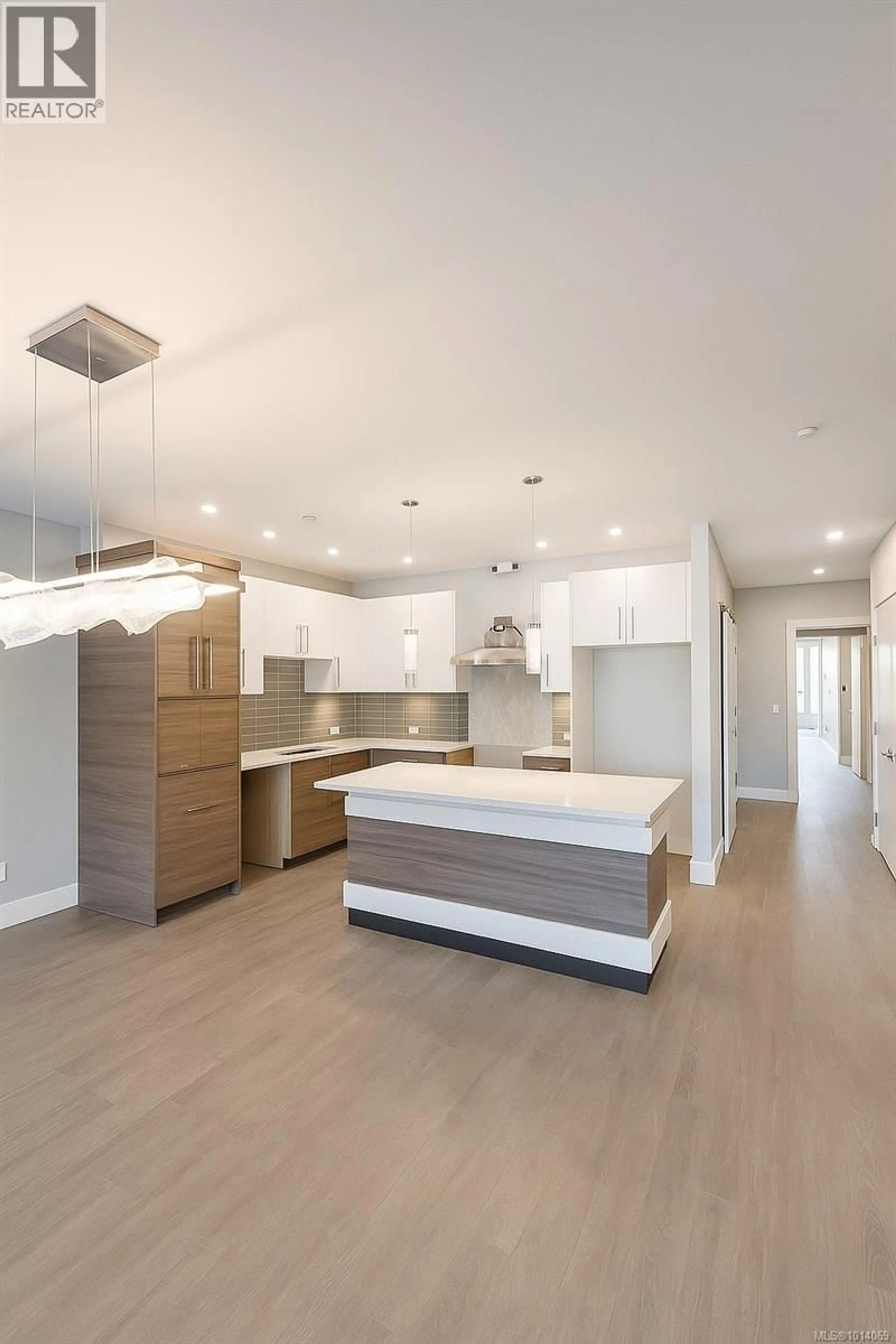Open concept kitchen, wood/laminate floor for 103 - 986 DOUMAC AVENUE, Saanich British Columbia V8Y1M4