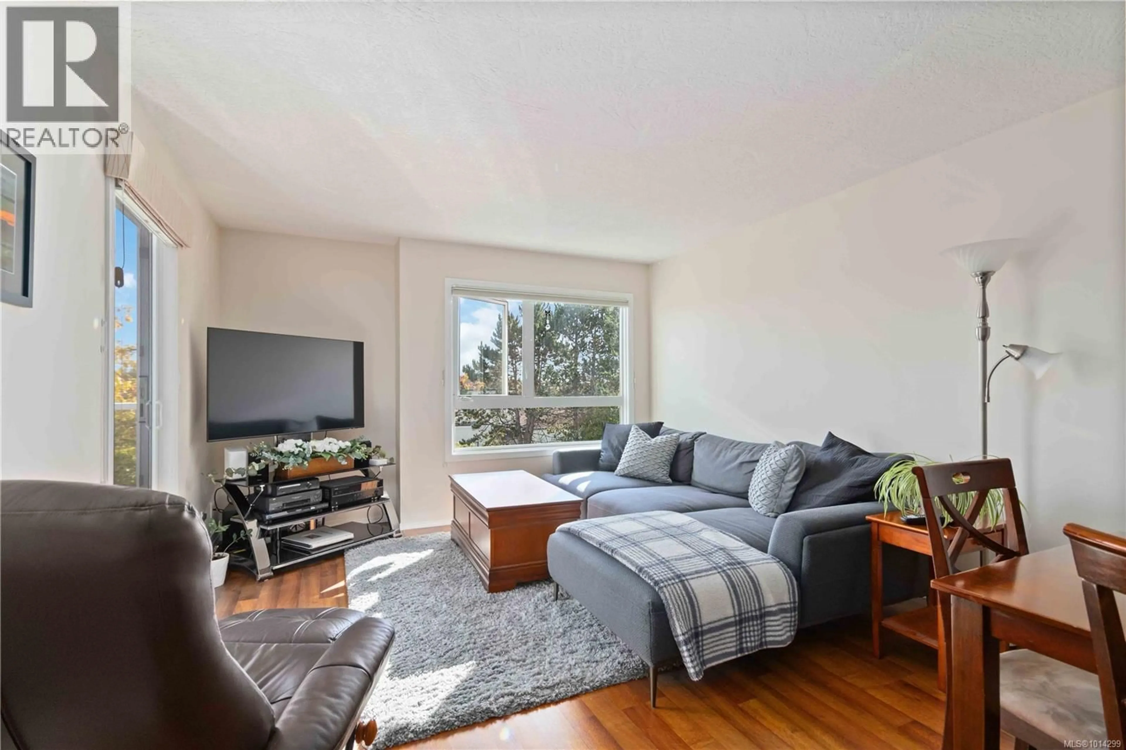 Living room with furniture, wood/laminate floor for 317 - 2245 JAMES WHITE BOULEVARD, Sidney British Columbia V8L1Z5
