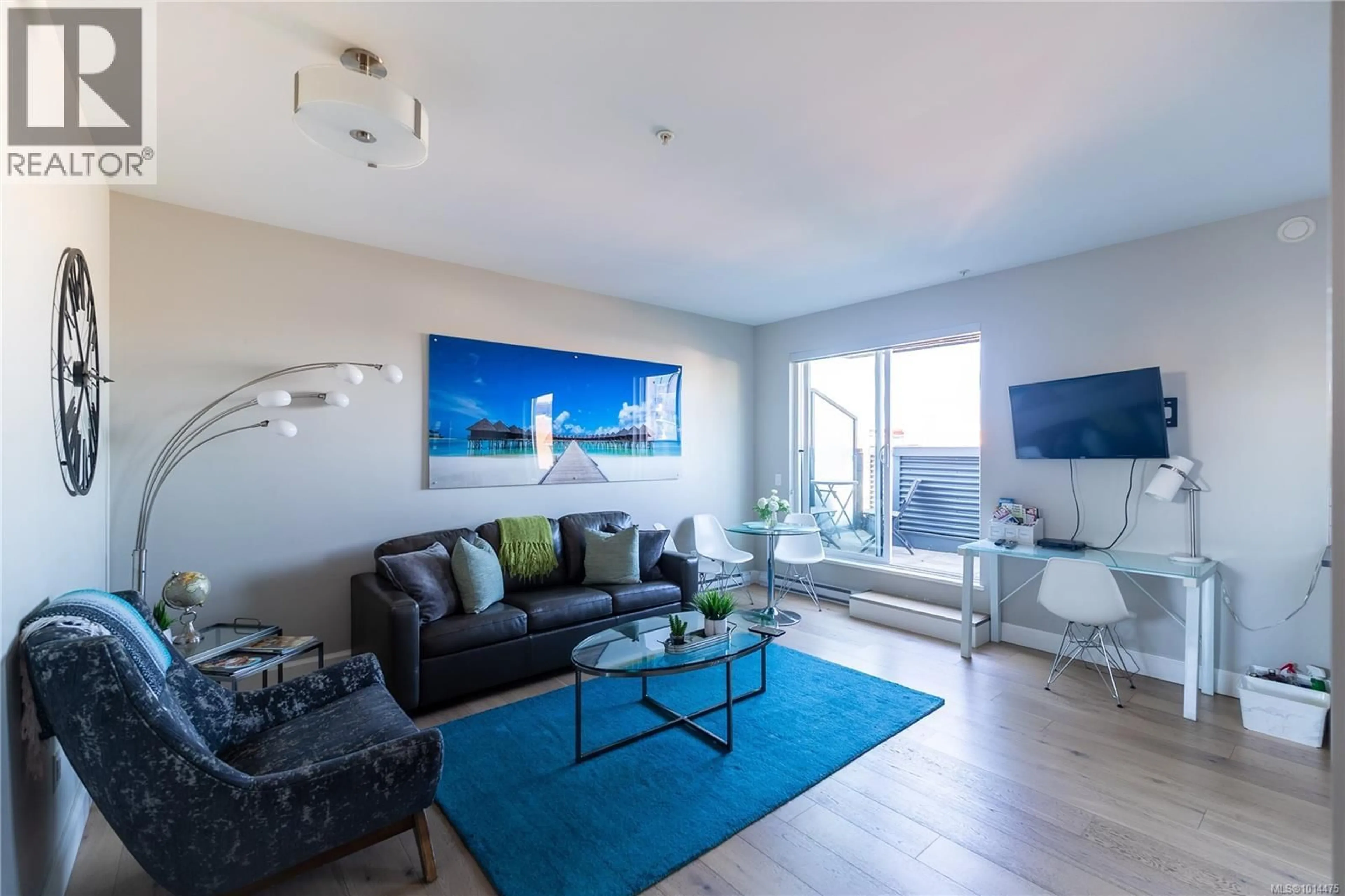 Living room with furniture, wood/laminate floor for 411 - 595 PANDORA AVENUE, Victoria British Columbia V8W1N4