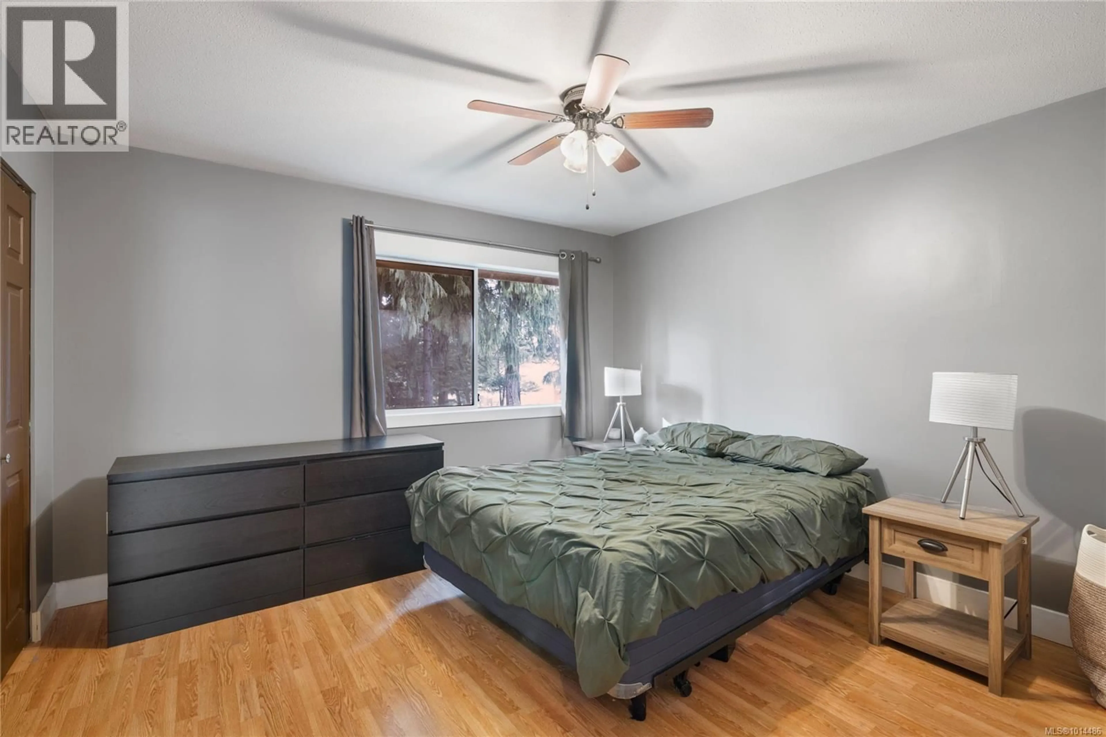 Bedroom with bed, wood/laminate floor for 6055 PLEASANT VALLEY WAY, Nanaimo British Columbia V9T6E7