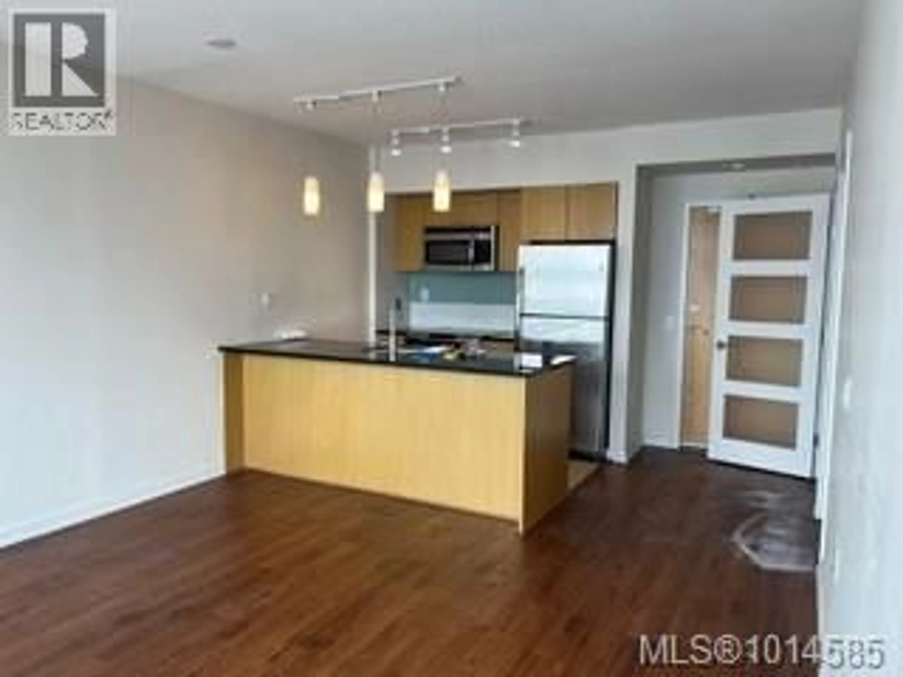 Open concept kitchen, wood/laminate floor for 704 - 834 JOHNSON STREET, Victoria British Columbia V8W1N3
