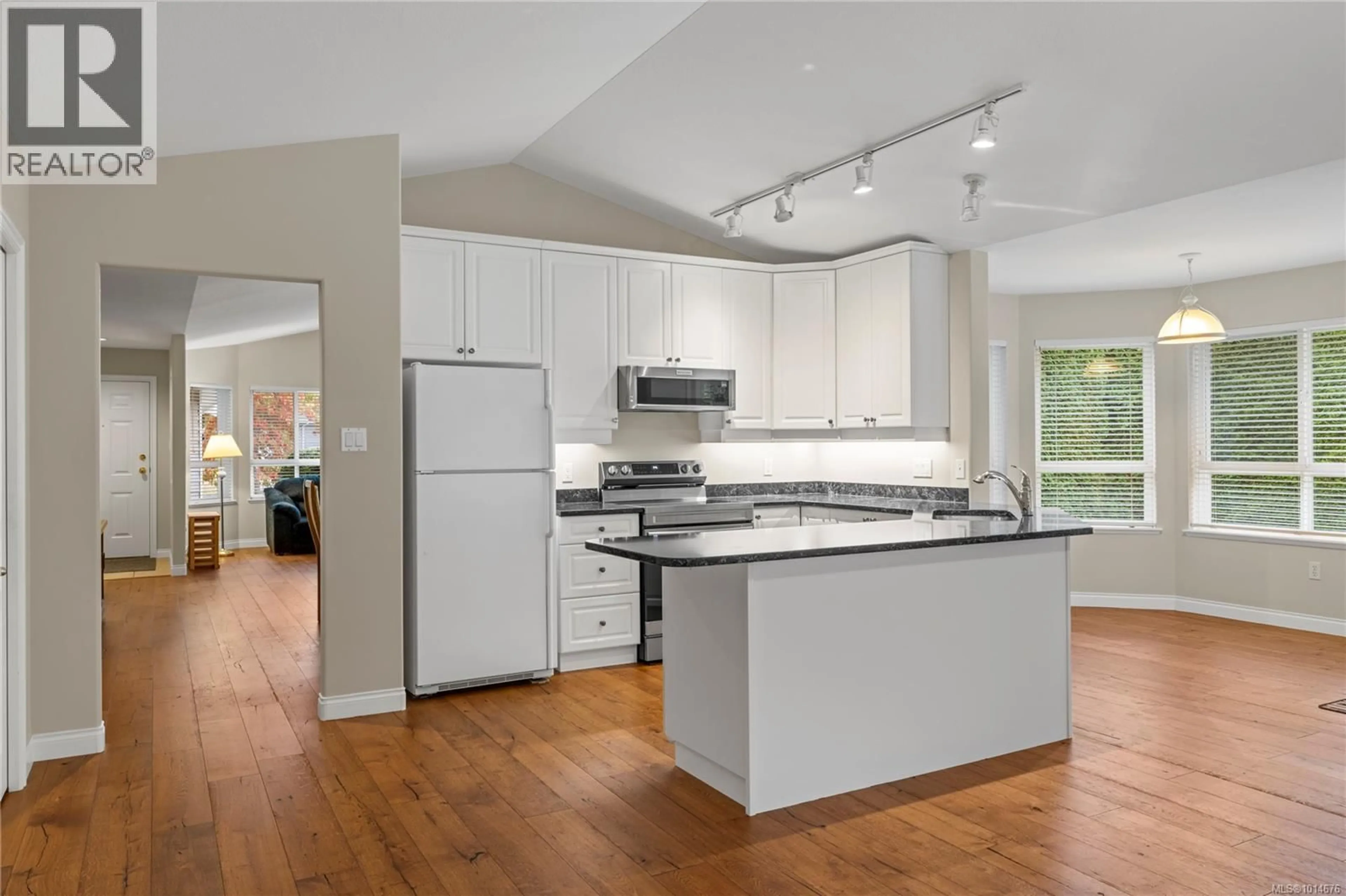 Open concept kitchen, wood/laminate floor for 1205 SATURNA DRIVE, Parksville British Columbia V9P2X5
