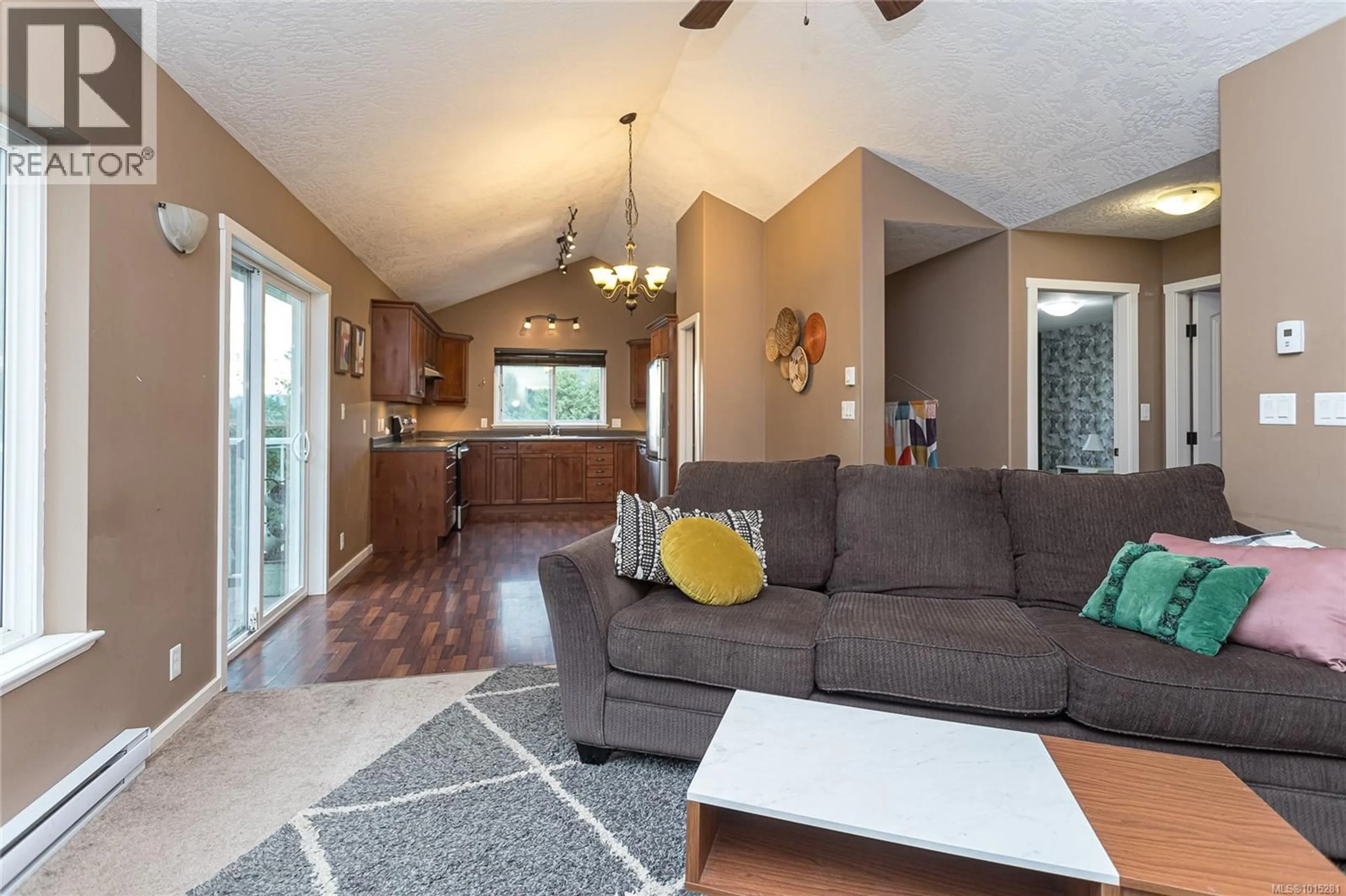 Living room with furniture, wood/laminate floor for 1759 MARTINI WAY, Qualicum Beach British Columbia V9K2S3