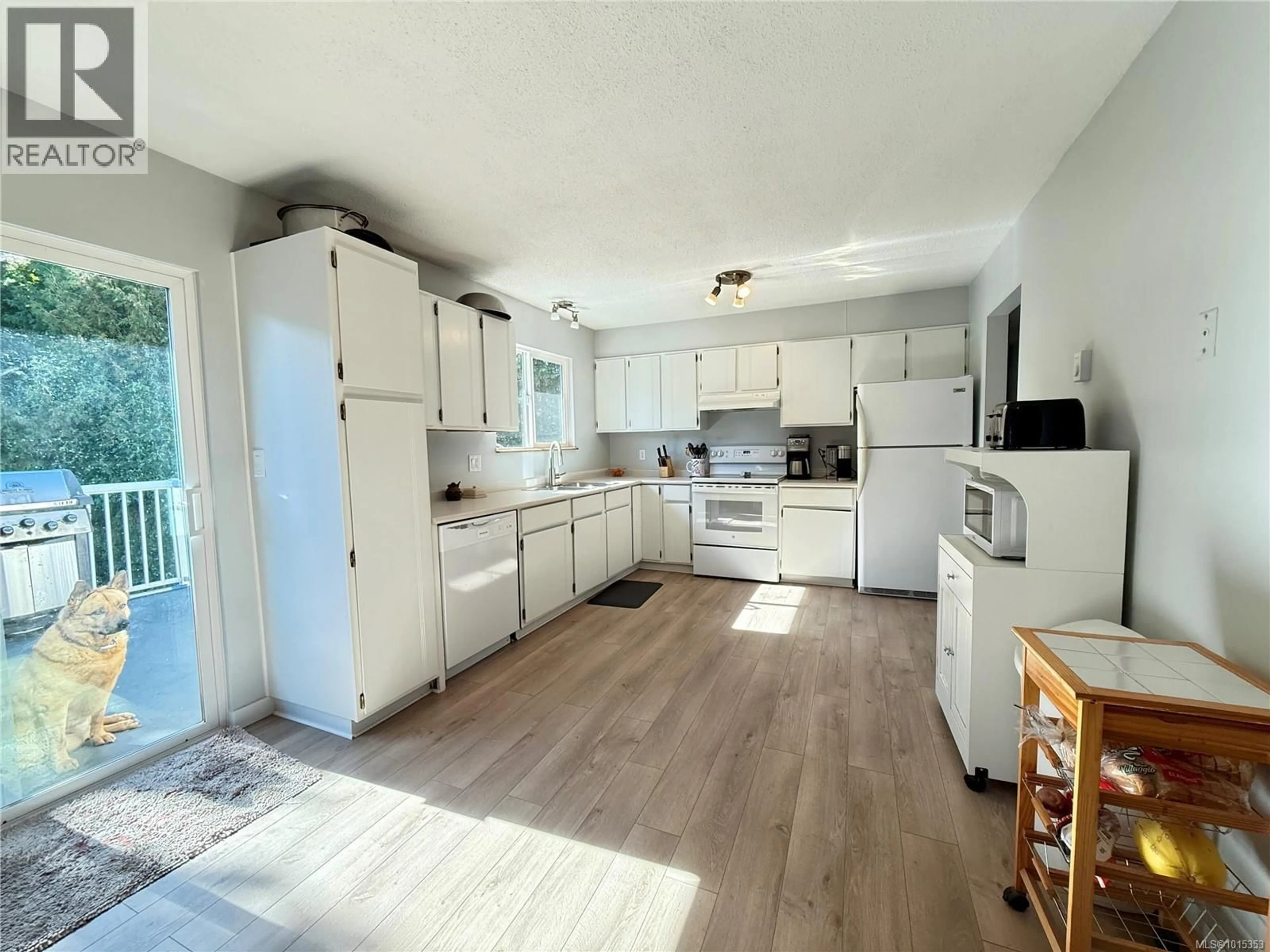 Open concept kitchen, wood/laminate floor for 2101 PIONEER HILL, Port McNeill British Columbia V0N2R0