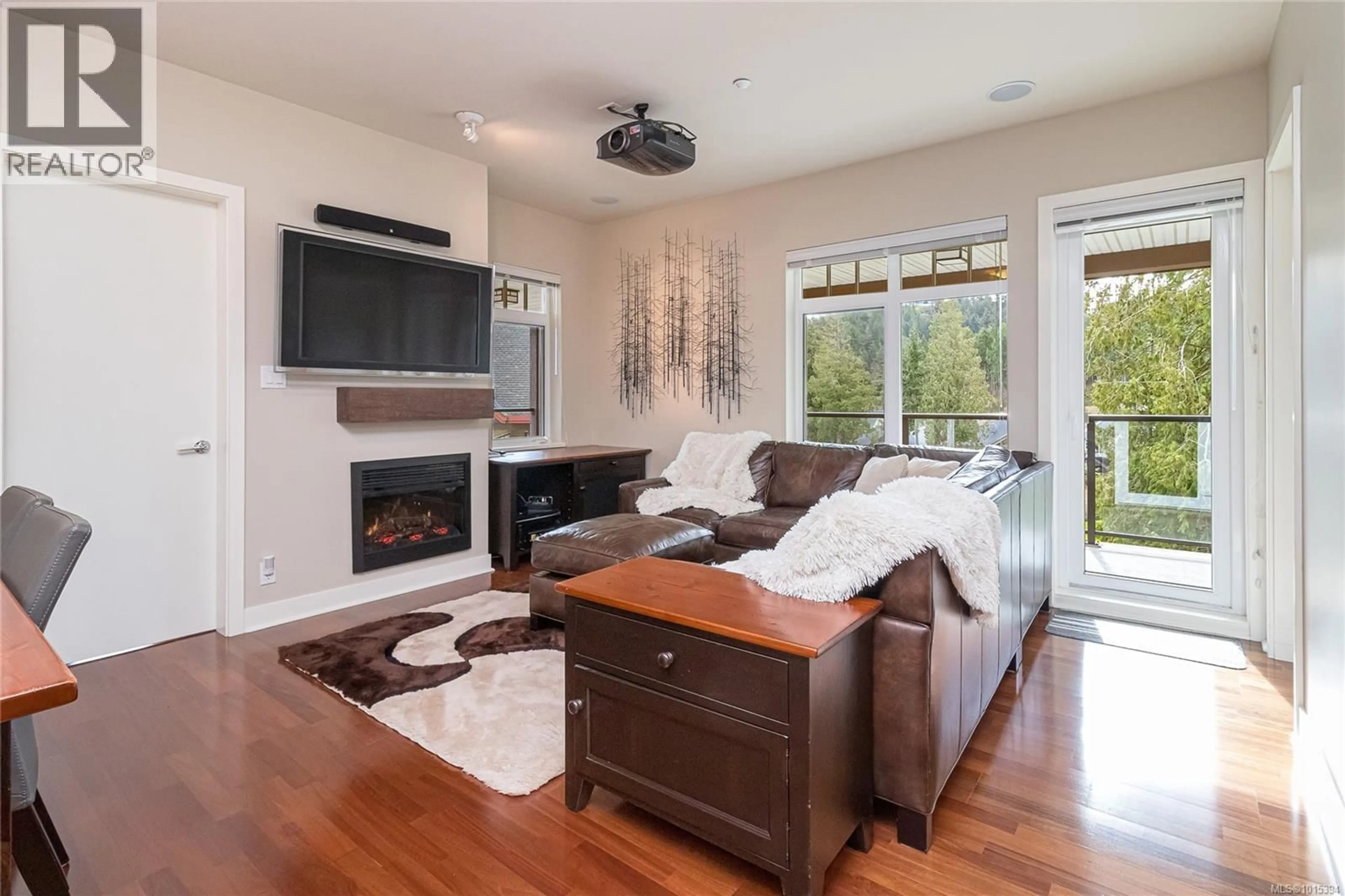 Living room with furniture, wood/laminate floor for 302 - 1395 BEAR MOUNTAIN PARKWAY, Langford British Columbia V9B0E1