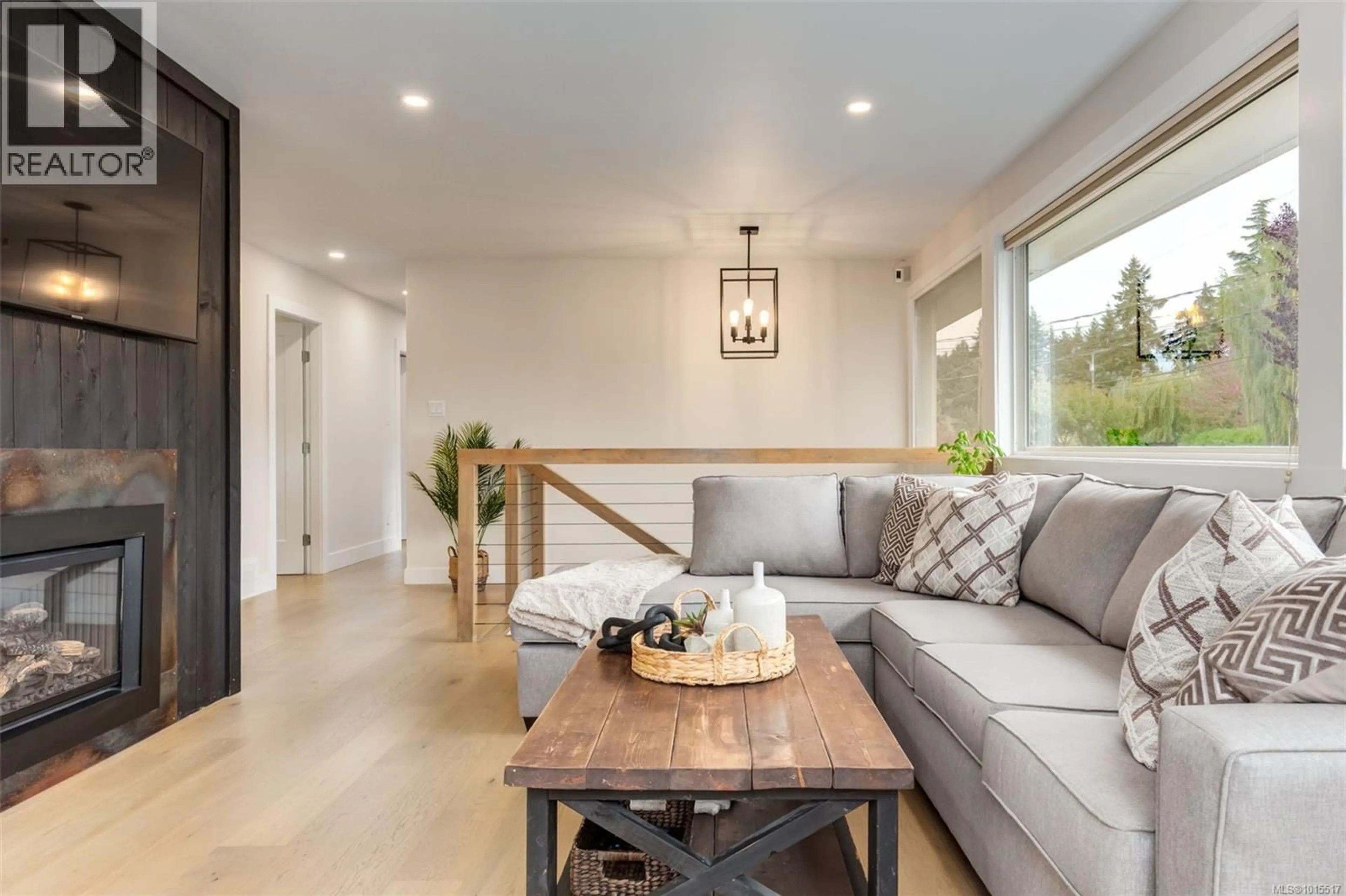 Living room with furniture, wood/laminate floor for 2420 GLENAYR DRIVE, Nanaimo British Columbia V9S3R7