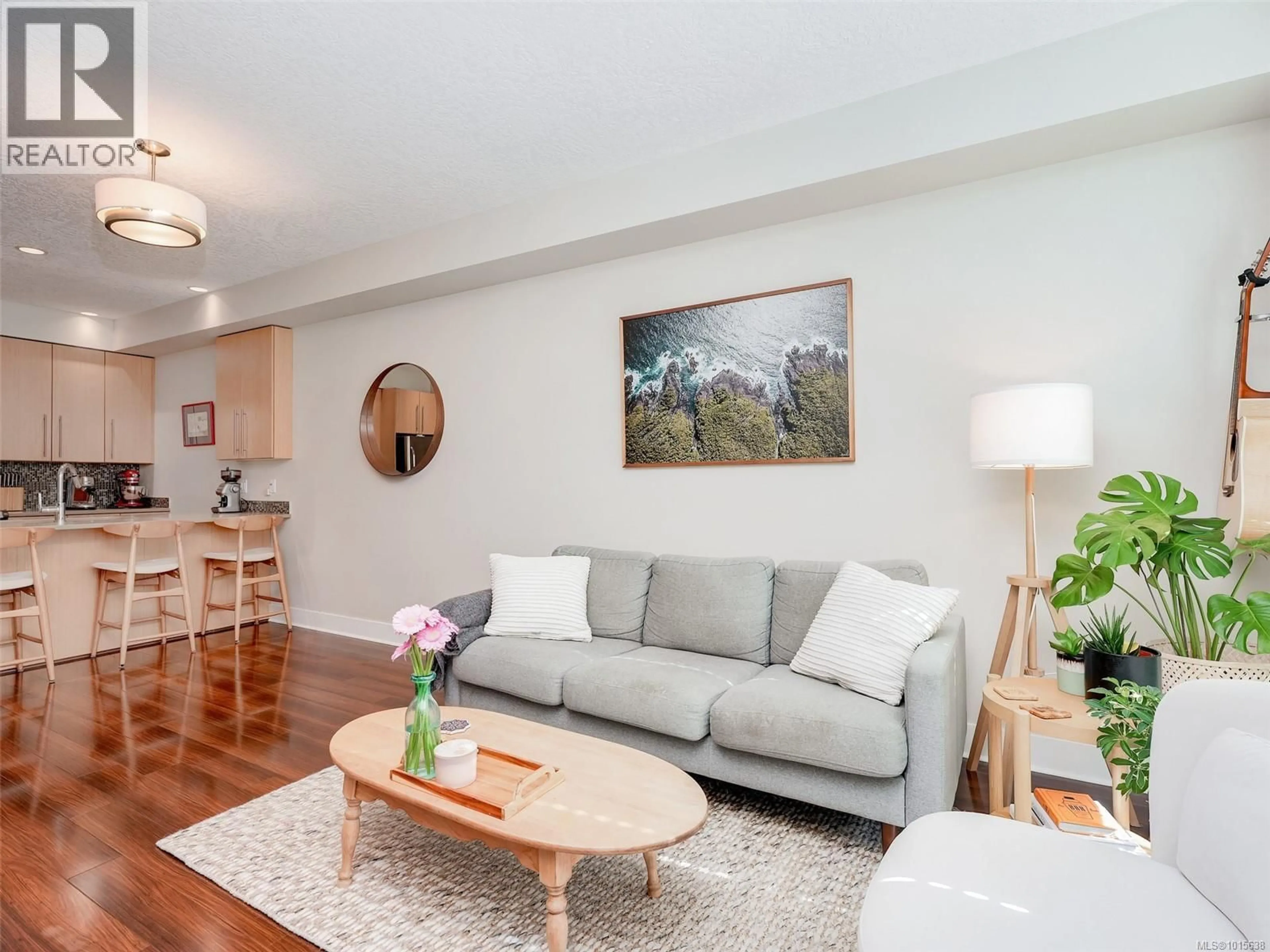 Living room with furniture, wood/laminate floor for 207 - 4529 WEST SAANICH ROAD, Saanich British Columbia V8Z3G3