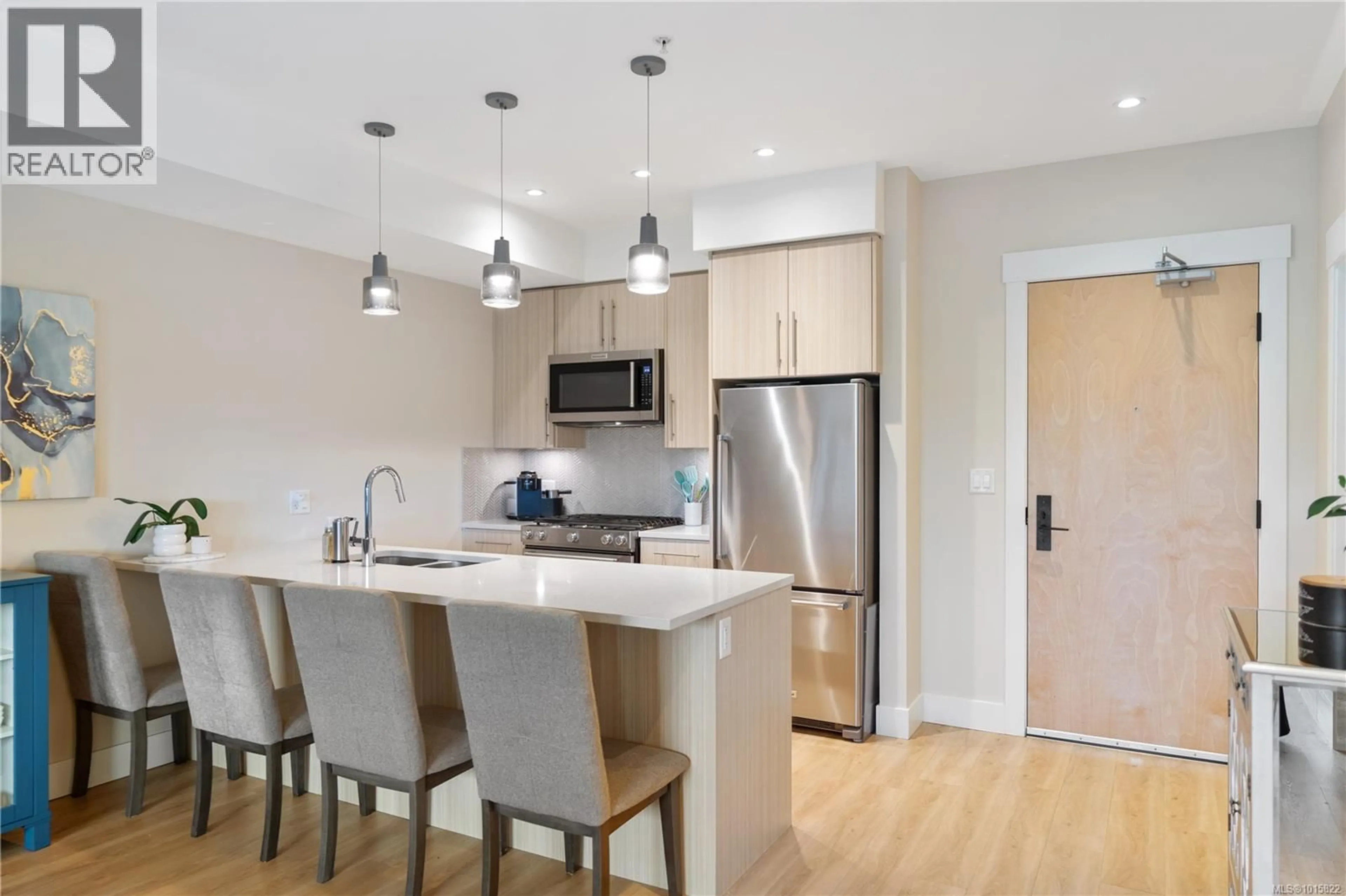 Open concept kitchen, wood/laminate floor for 303 - 2500 HACKETT CRESCENT, Central Saanich British Columbia V8M0C1
