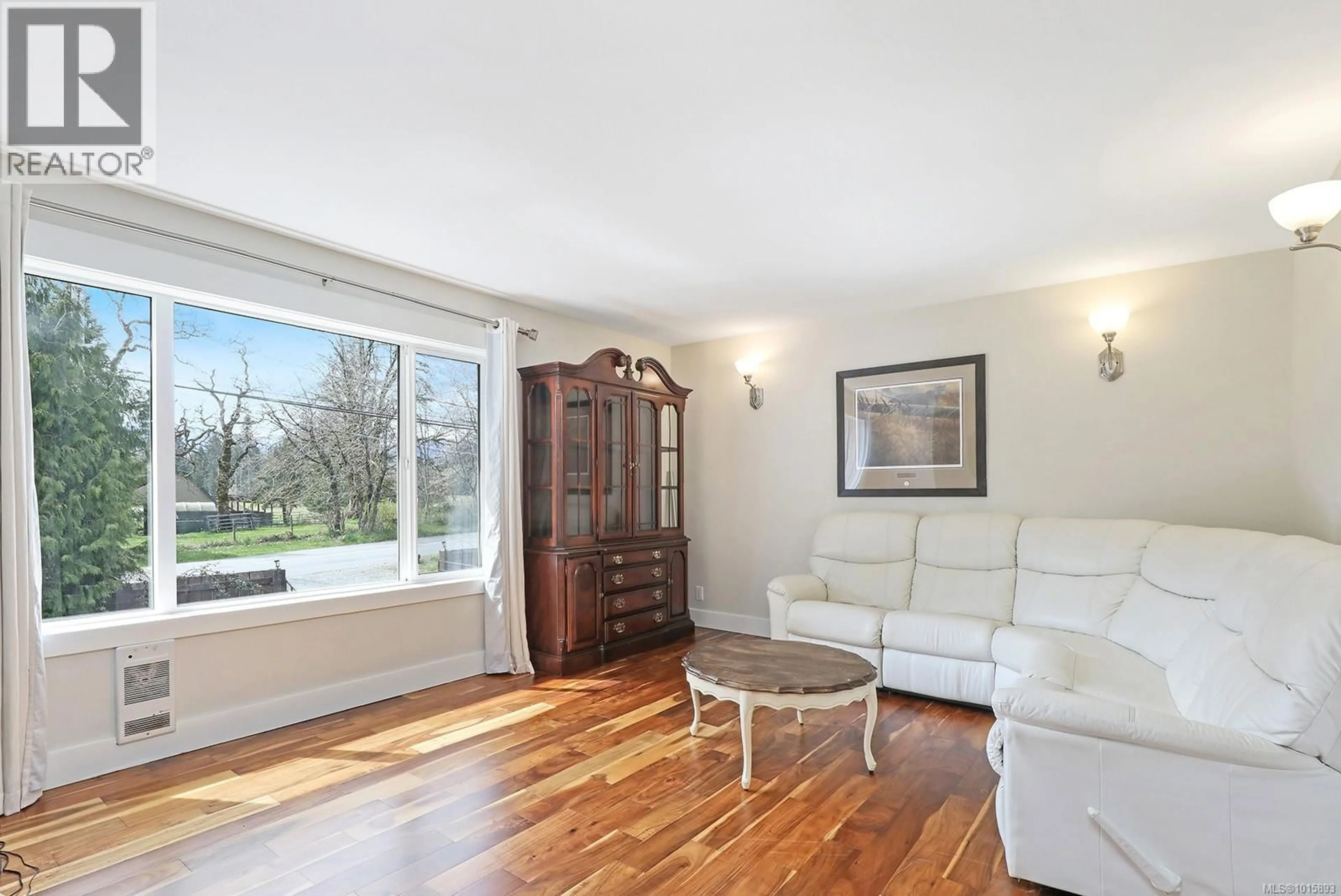 Living room with furniture, wood/laminate floor for 5252 HEADQUARTERS ROAD, Courtenay British Columbia V9J1M1