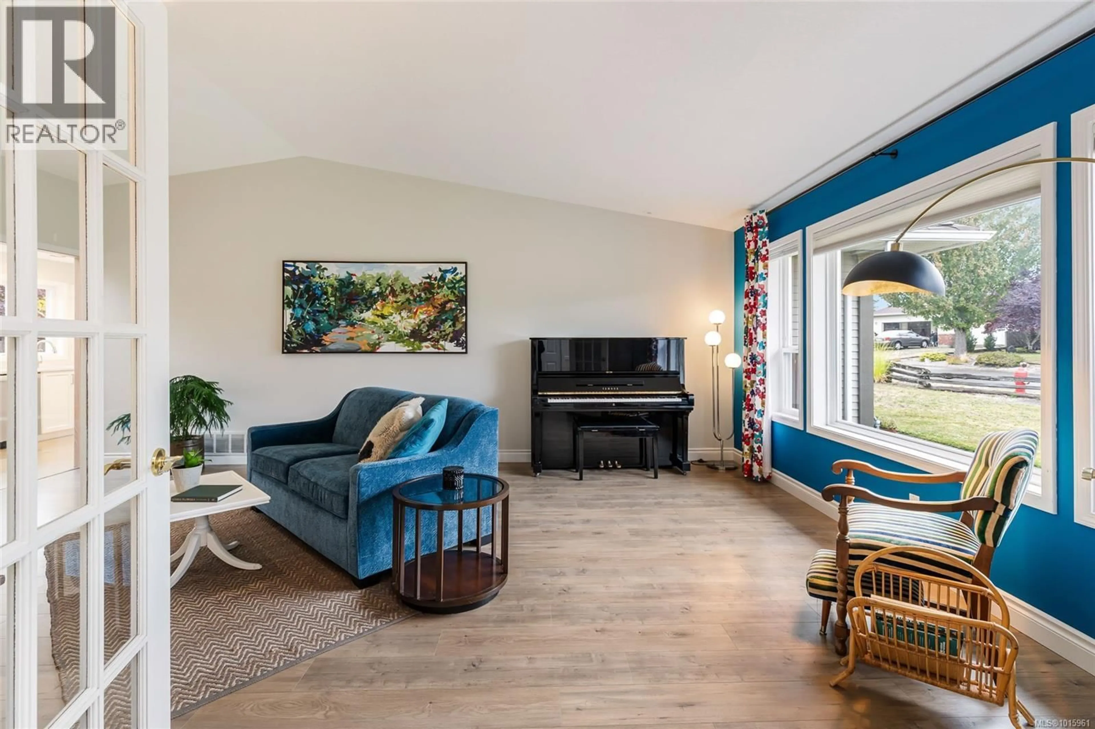 Living room with furniture, wood/laminate floor for 704 FOXTAIL AVENUE, Parksville British Columbia V9P2S3