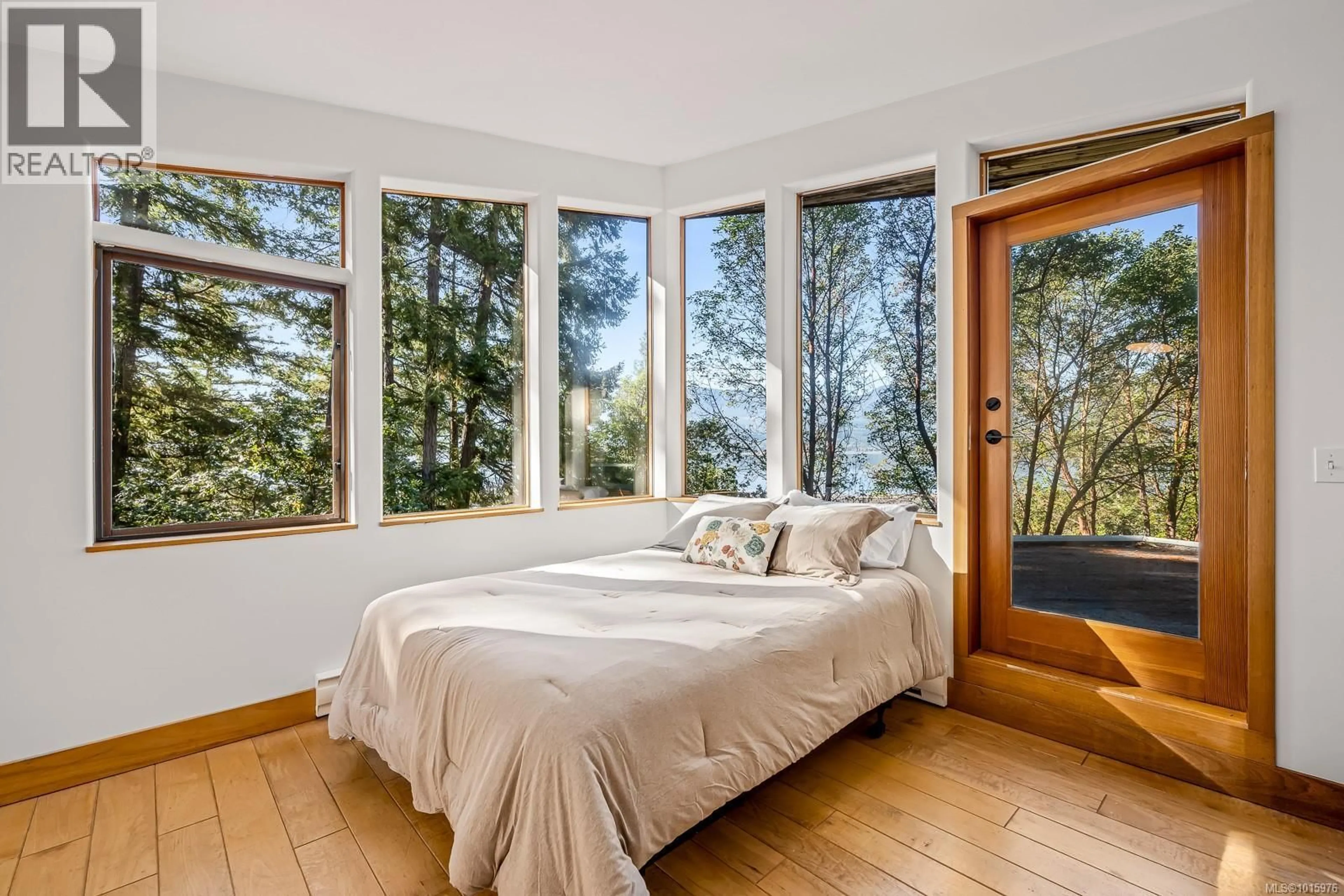 Bedroom with bed, wood/laminate floor for 6161 LACON ROAD, Denman Island British Columbia V0R1T0