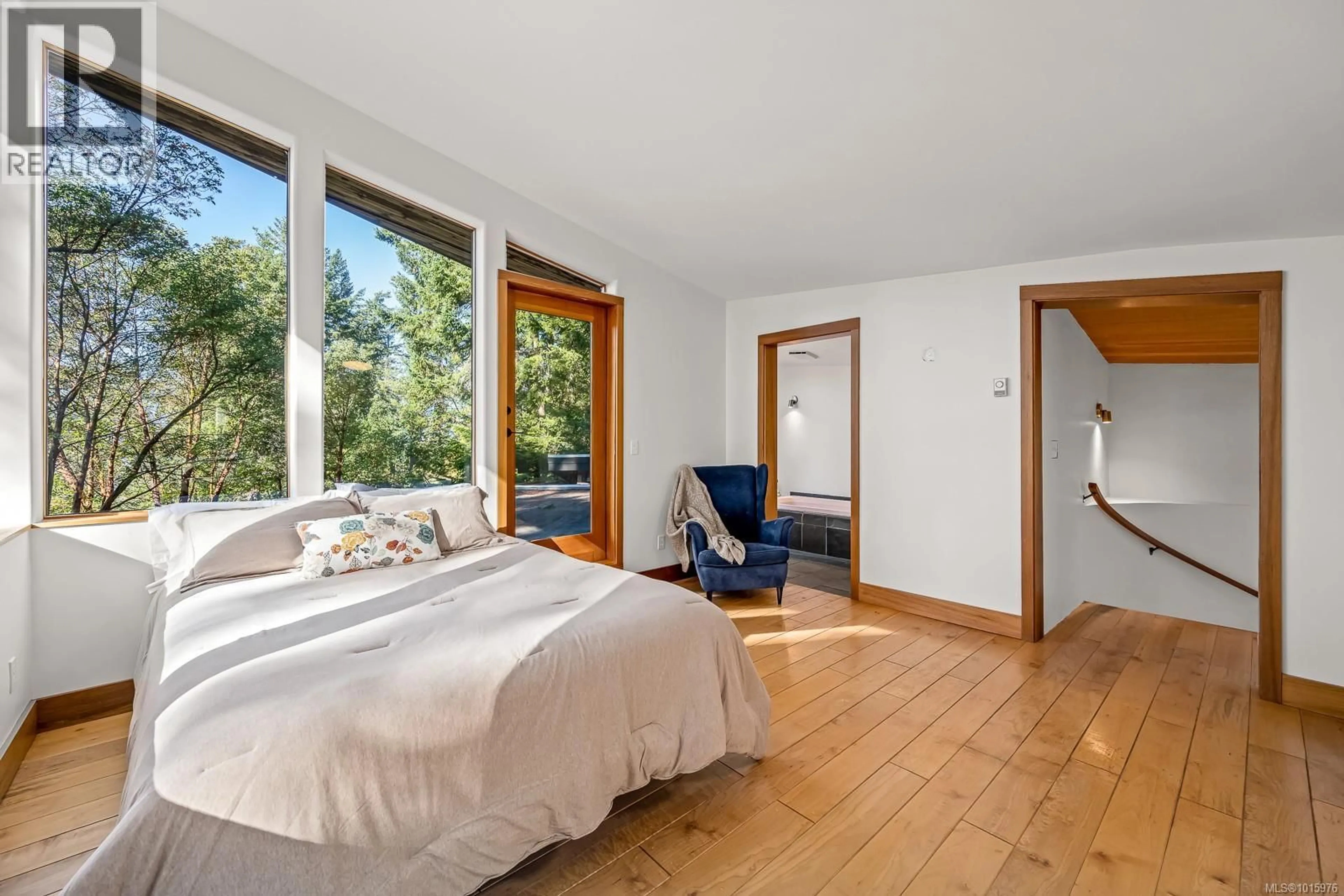Bedroom with bed, wood/laminate floor for 6161 LACON ROAD, Denman Island British Columbia V0R1T0