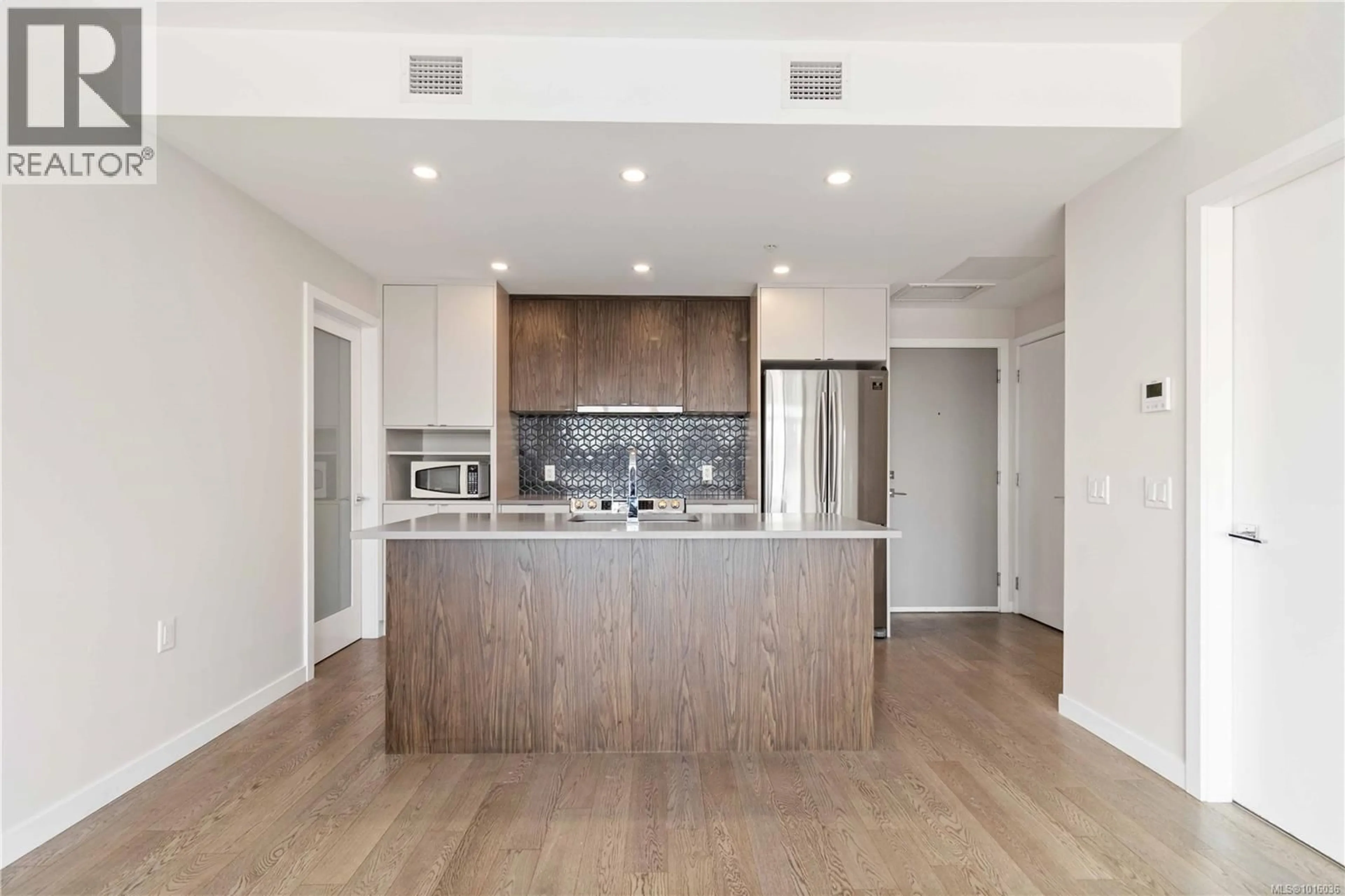 Open concept kitchen, wood/laminate floor for 311 - 881 SHORT STREET, Saanich British Columbia V8P2L3