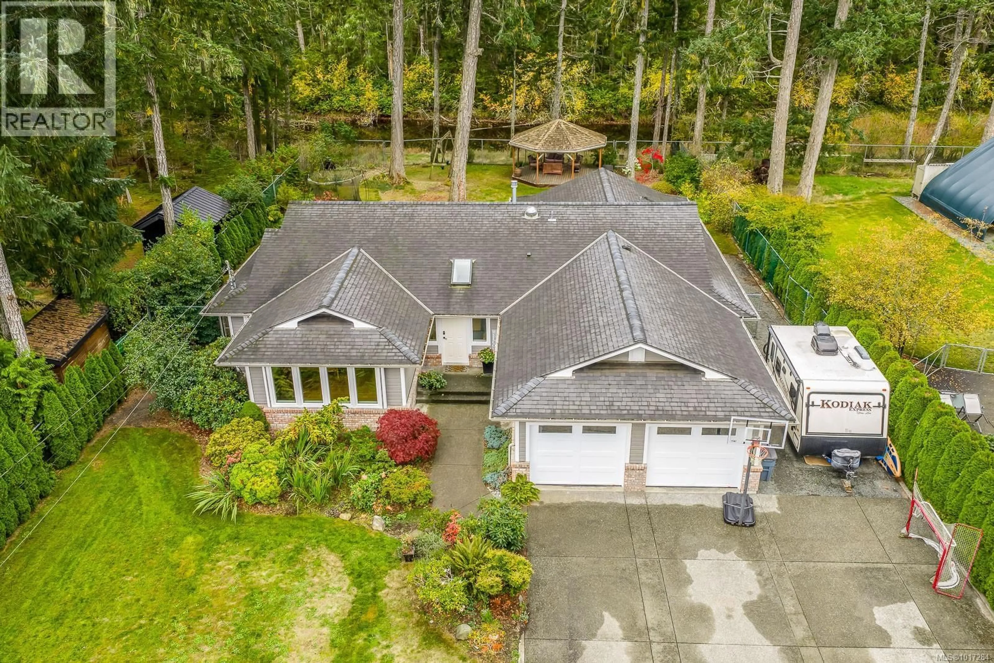 A pic from outside/outdoor area/front of a property/back of a property/a pic from drone, street for 8809 DRIFTWOOD ROAD, Black Creek British Columbia V9J1A8