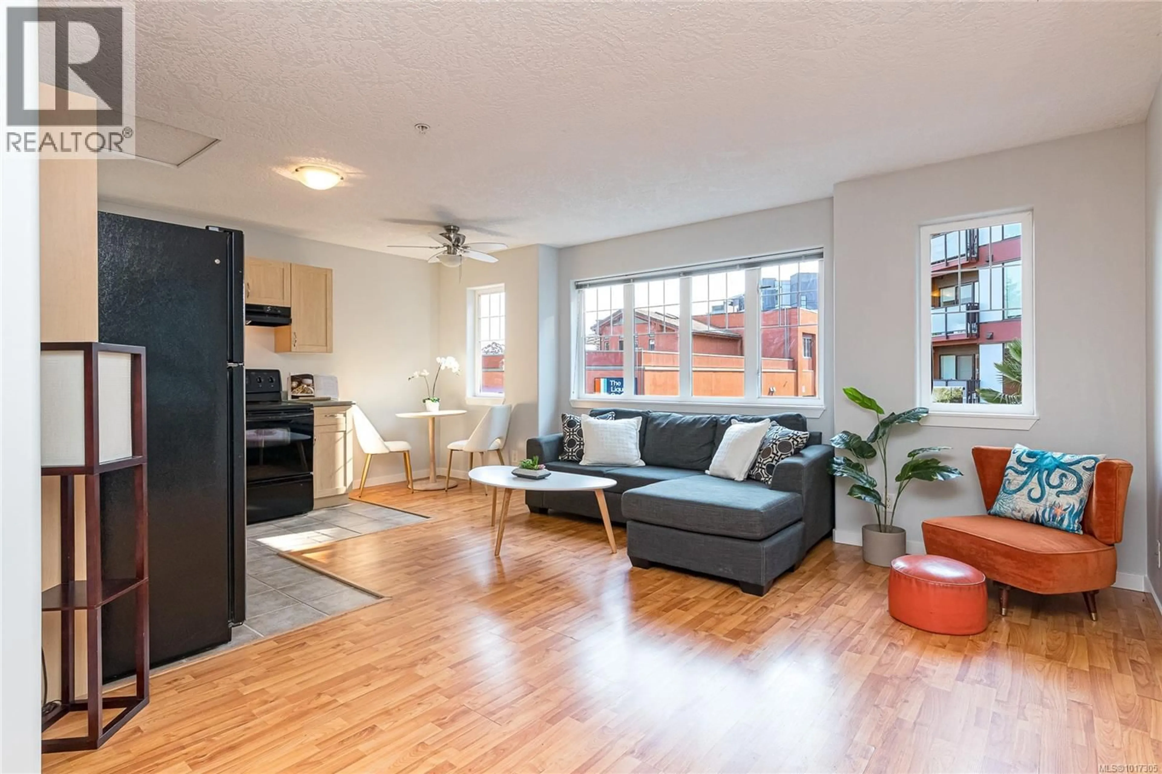 Living room with furniture, wood/laminate floor for 203 - 2844 BRYN MAUR ROAD, Langford British Columbia L1L1L1