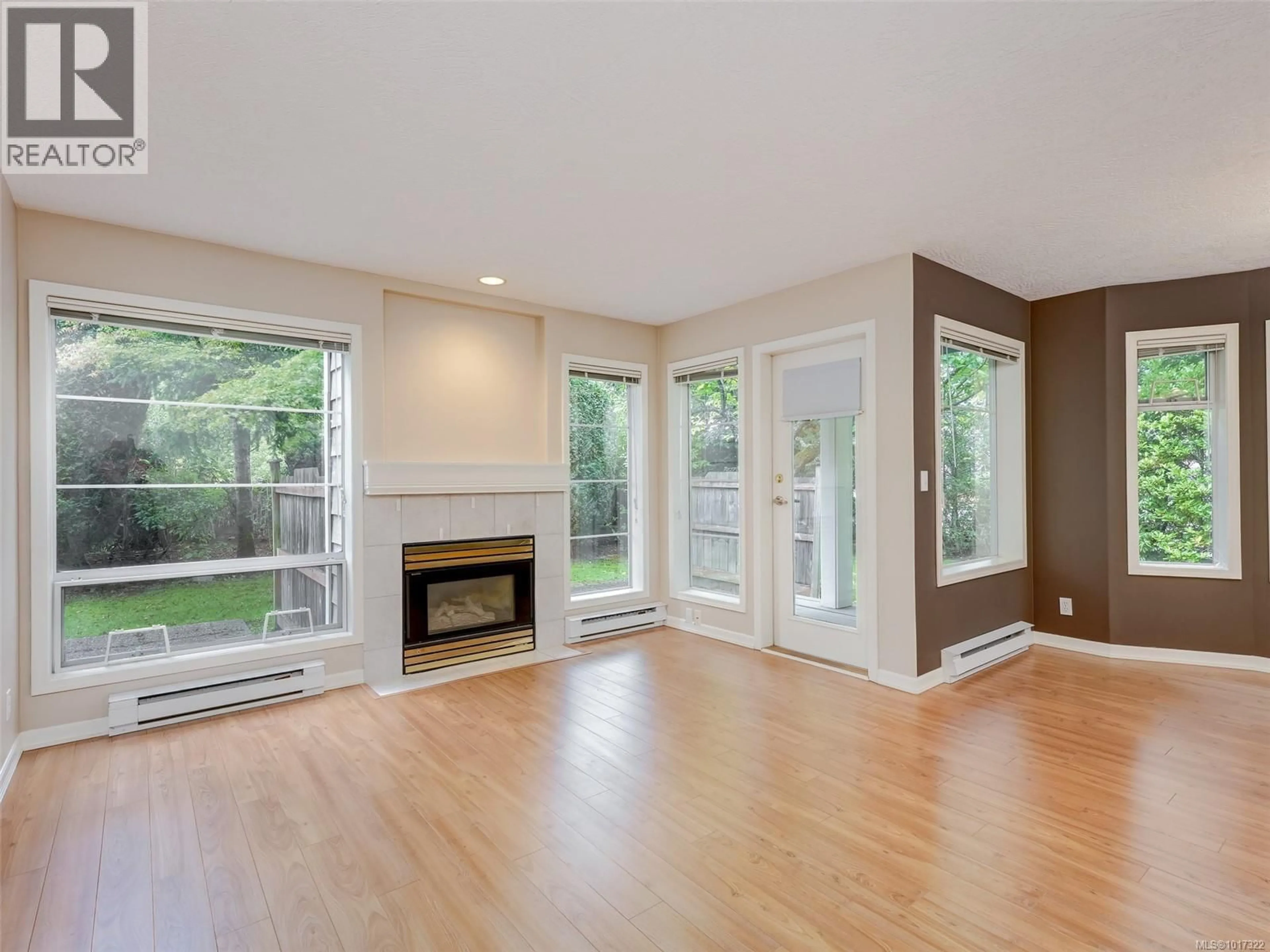 Living room with furniture, wood/laminate floor for 1 - 4619 ELK LAKE DRIVE, Saanich British Columbia V8Z5M2
