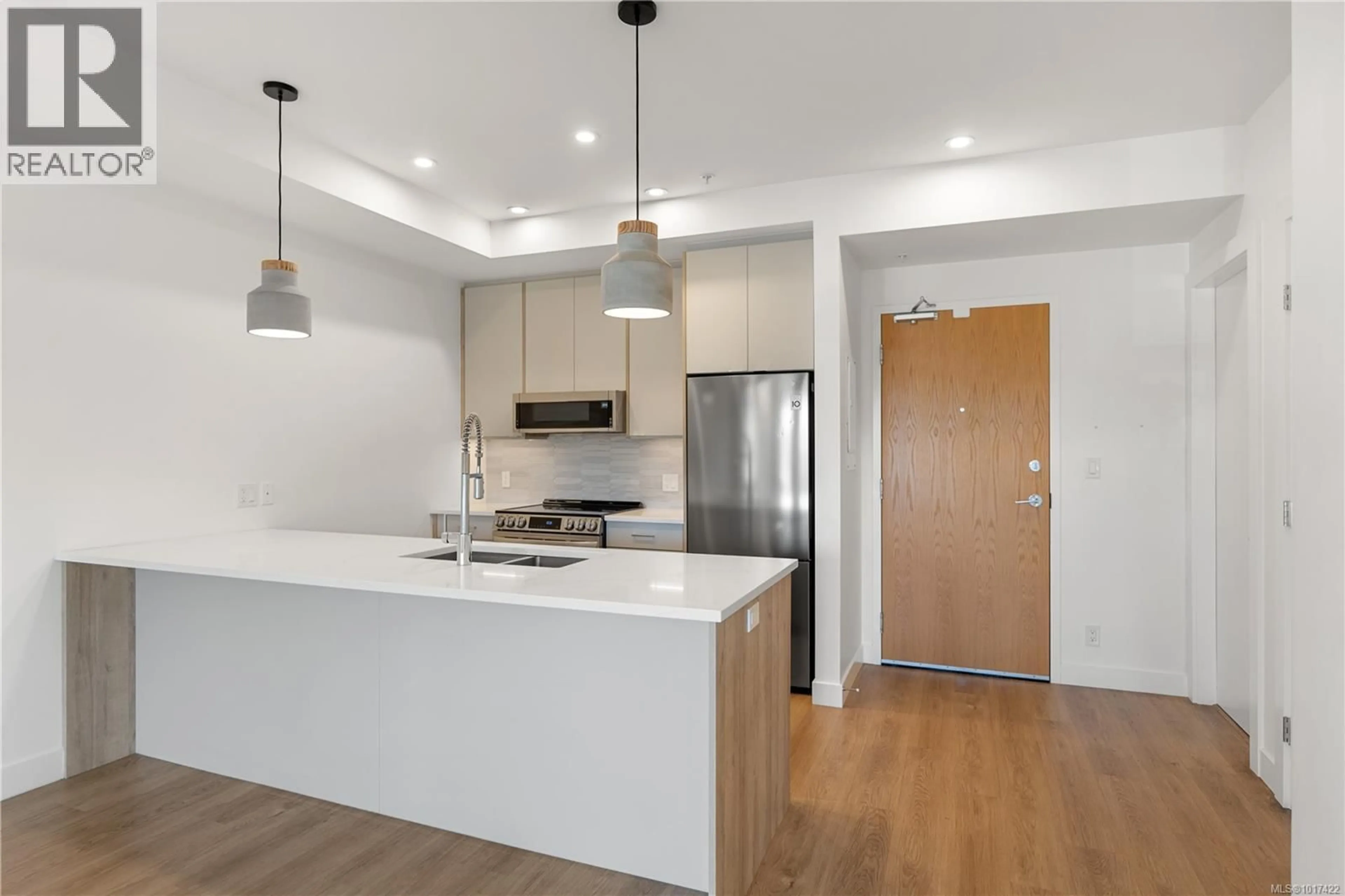 Open concept kitchen, wood/laminate floor for 402 - 757 TYEE ROAD, Victoria British Columbia V9A7P7