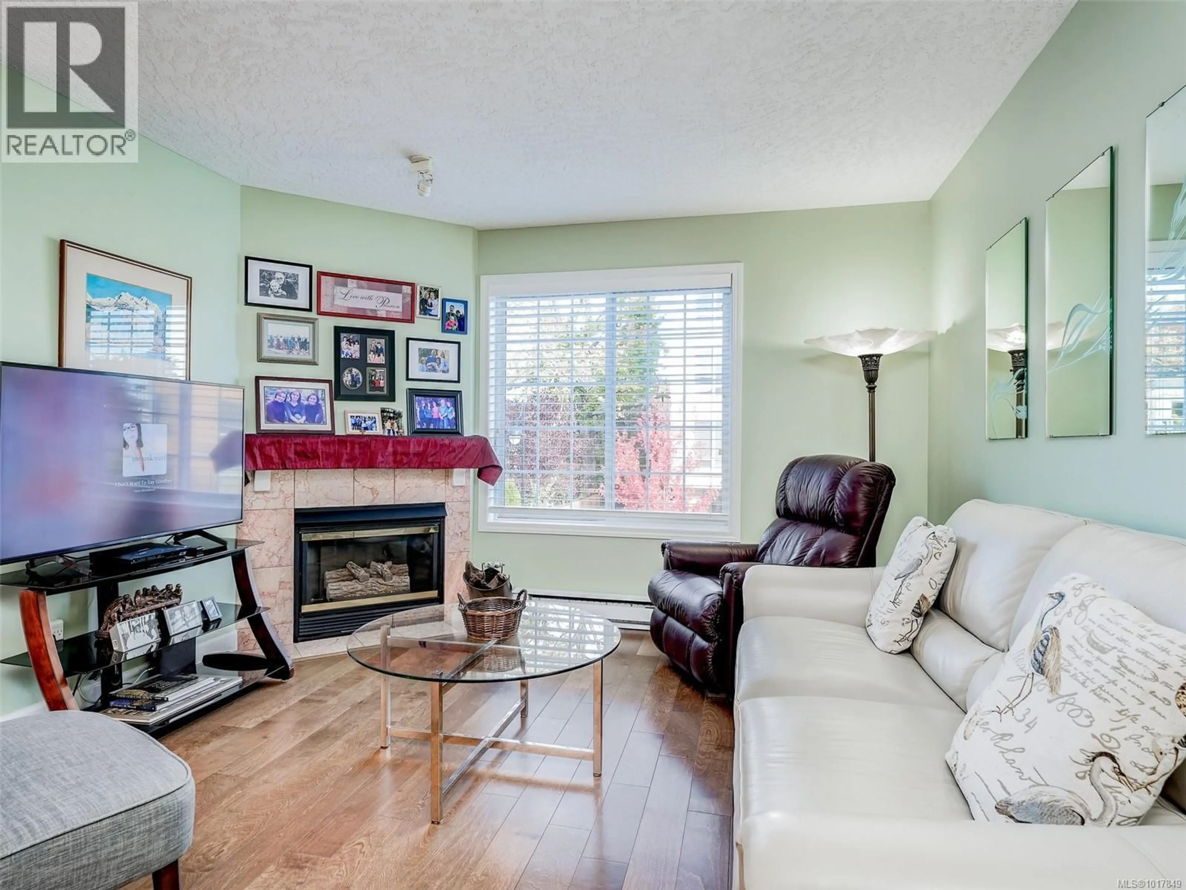 Living room with furniture, wood/laminate floor for 201 - 2421 SIDNEY AVENUE, Sidney British Columbia V8L1Y8