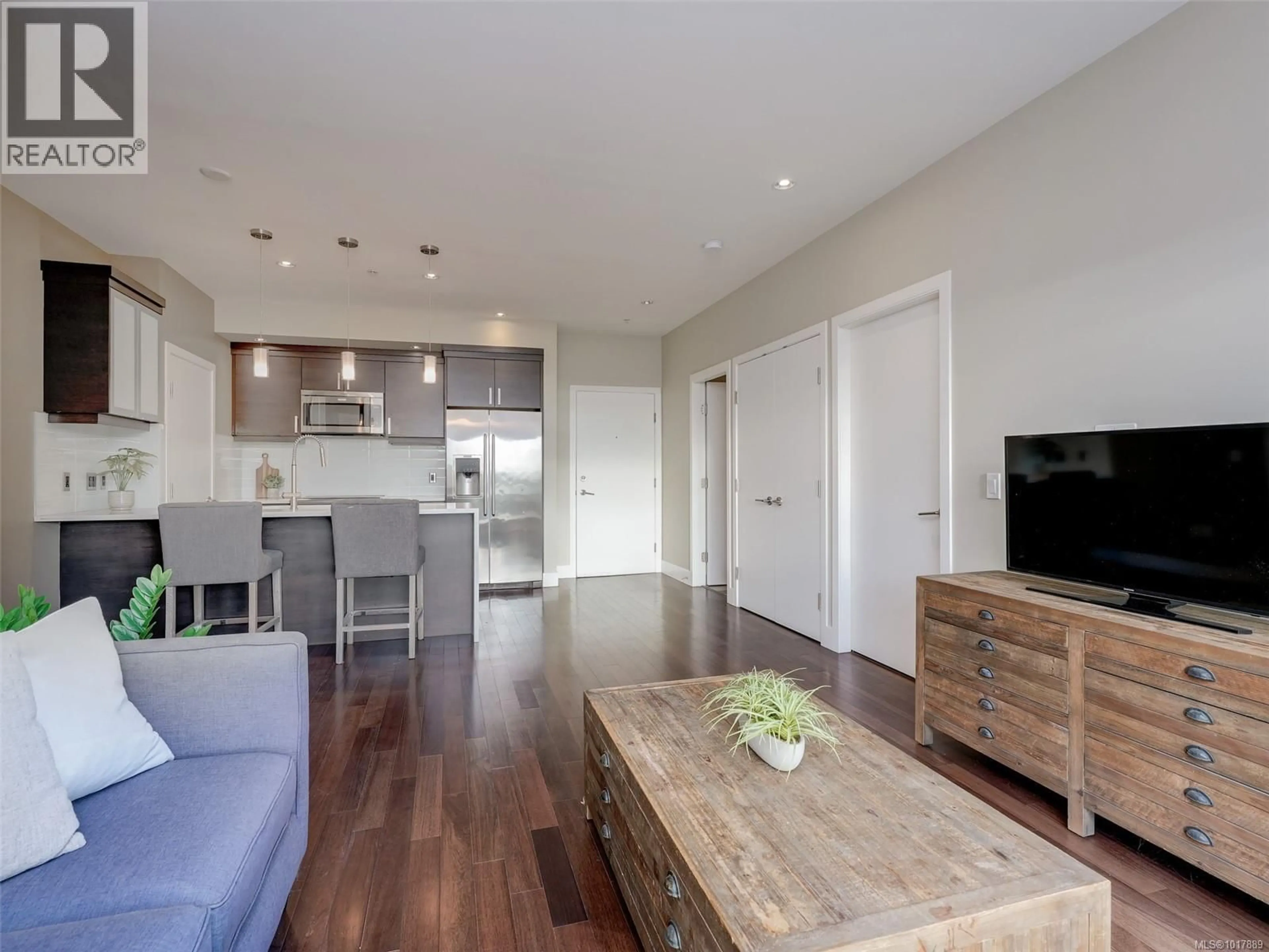 Open concept kitchen, wood/laminate floor for 204 - 2589 PENRHYN STREET, Saanich British Columbia V8N1G4
