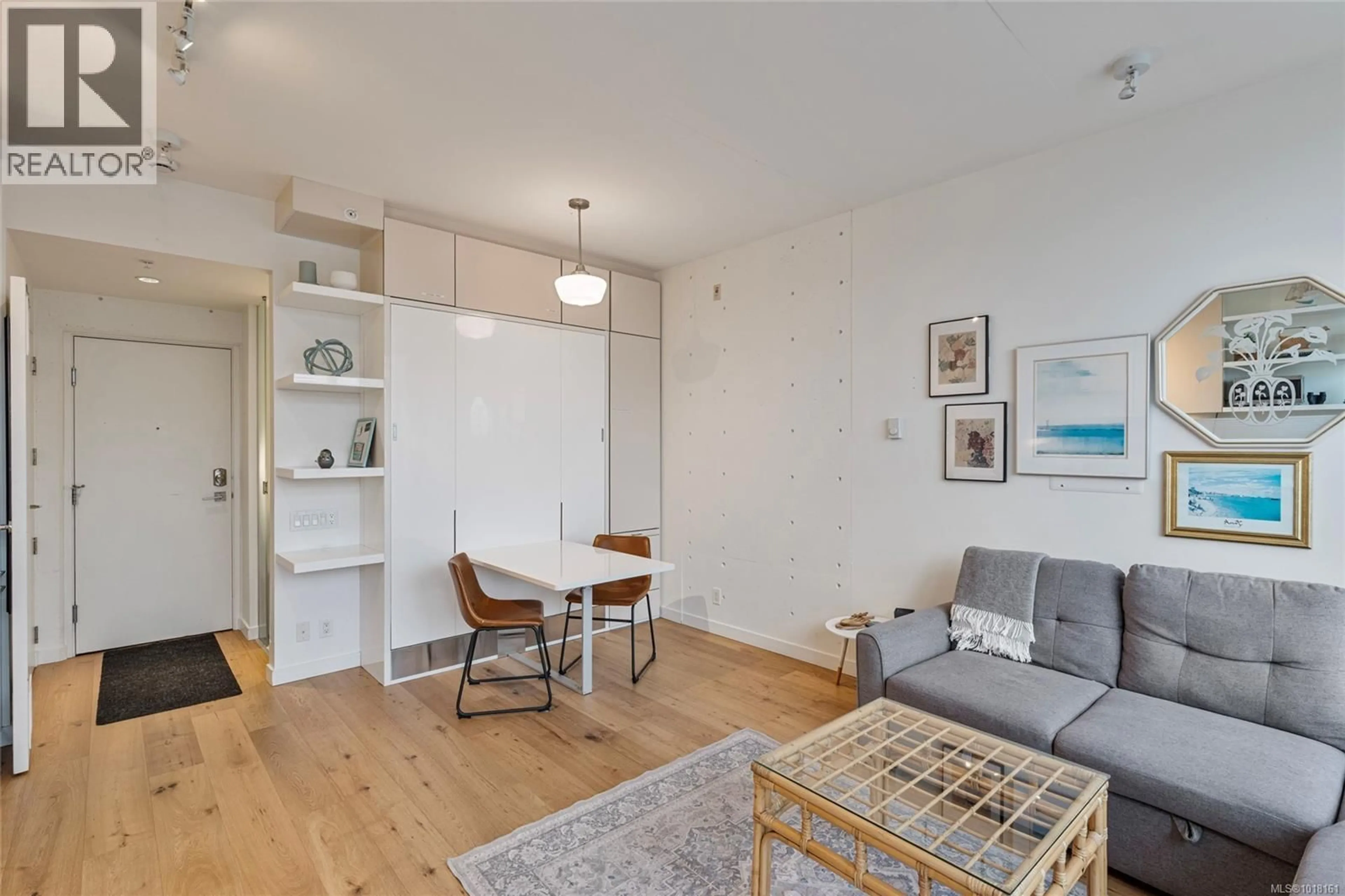Living room with furniture, wood/laminate floor for 211 - 456 PANDORA AVENUE, Victoria British Columbia V8W0E3