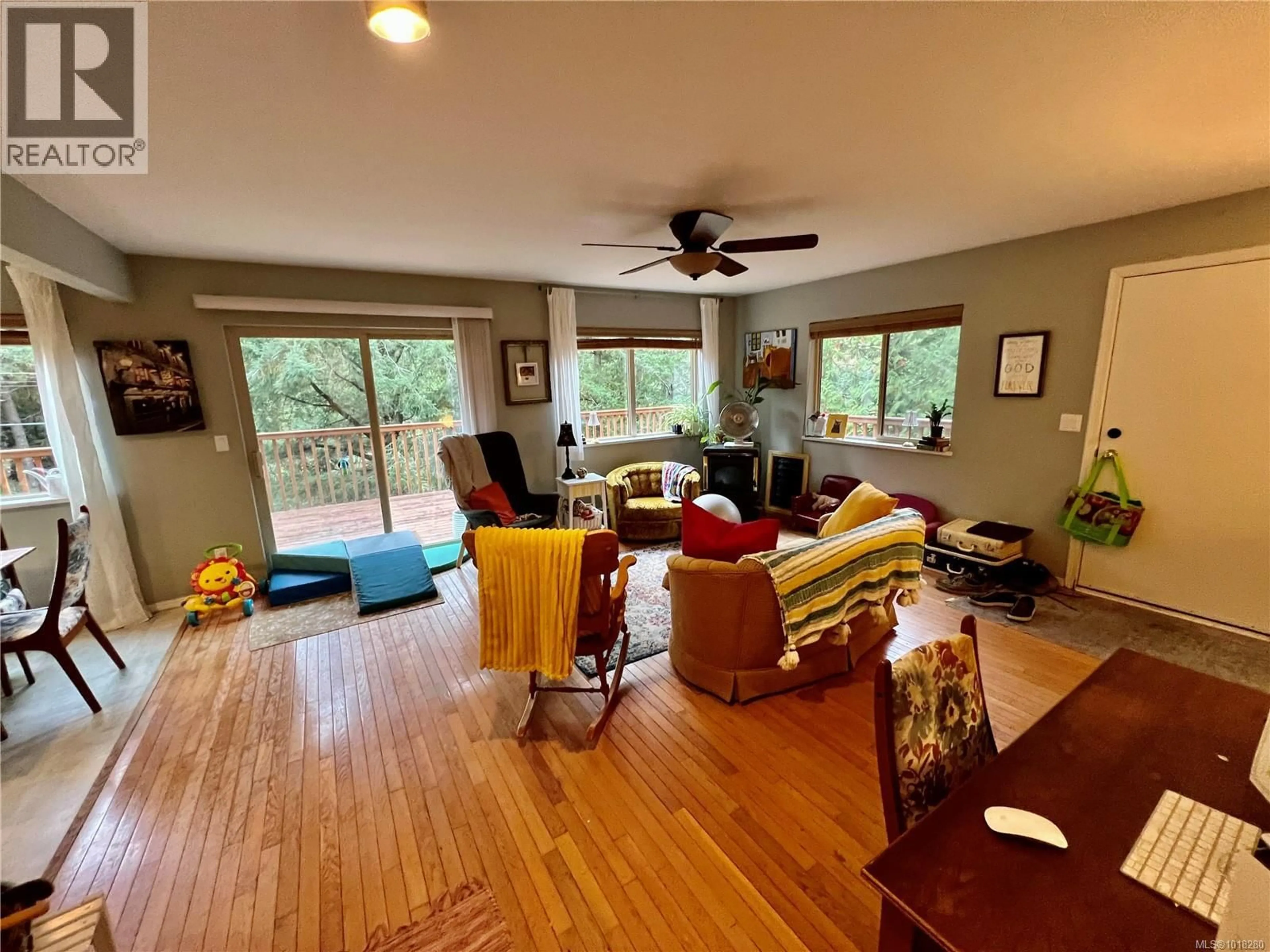 Living room with furniture, wood/laminate floor for 702 CHARTER ROAD, Mayne Island British Columbia V0N2J1