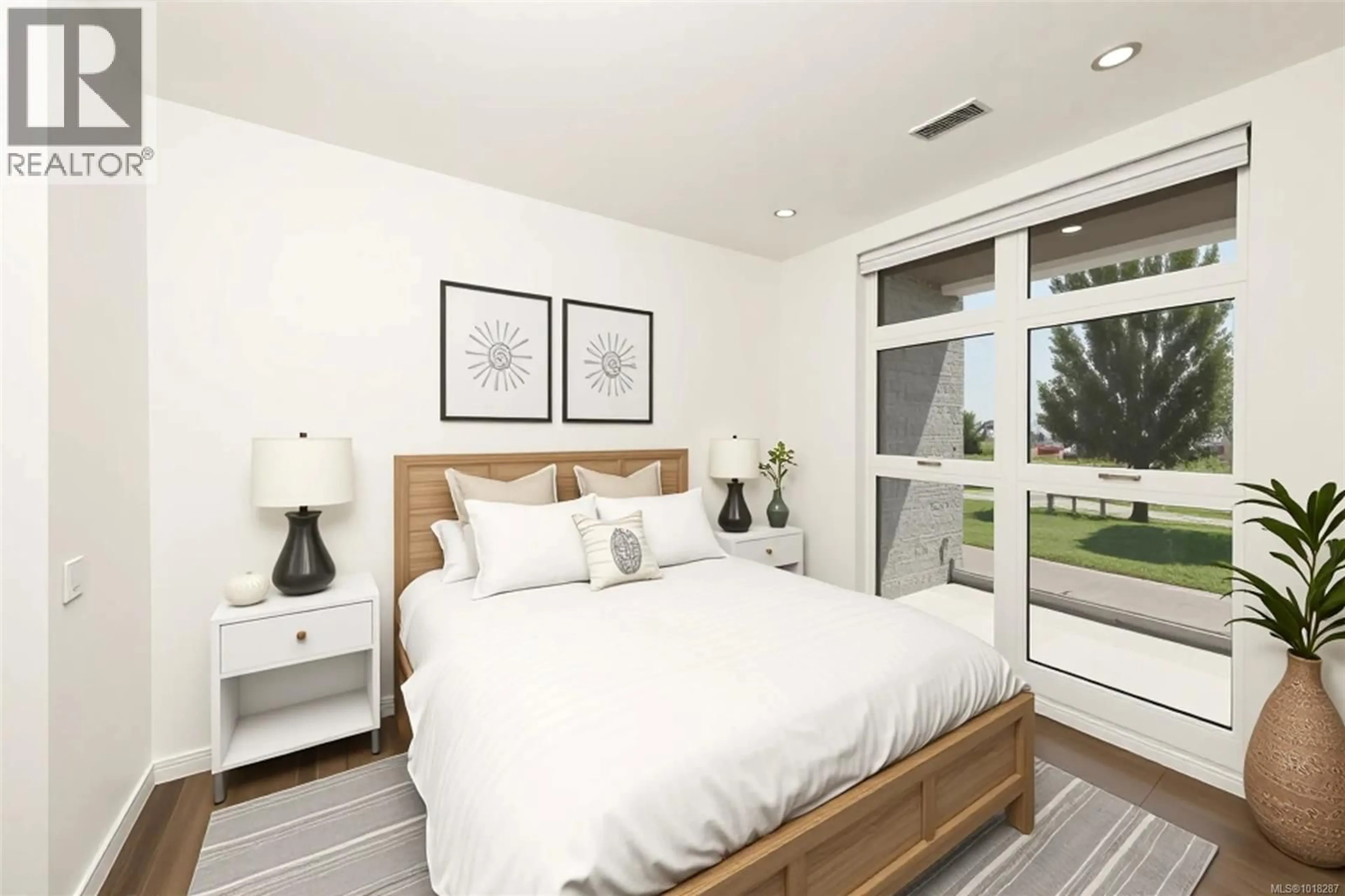 Bedroom with bed, wood/laminate floor for 204 - 9570 FIFTH STREET, Sidney British Columbia V8L2W5