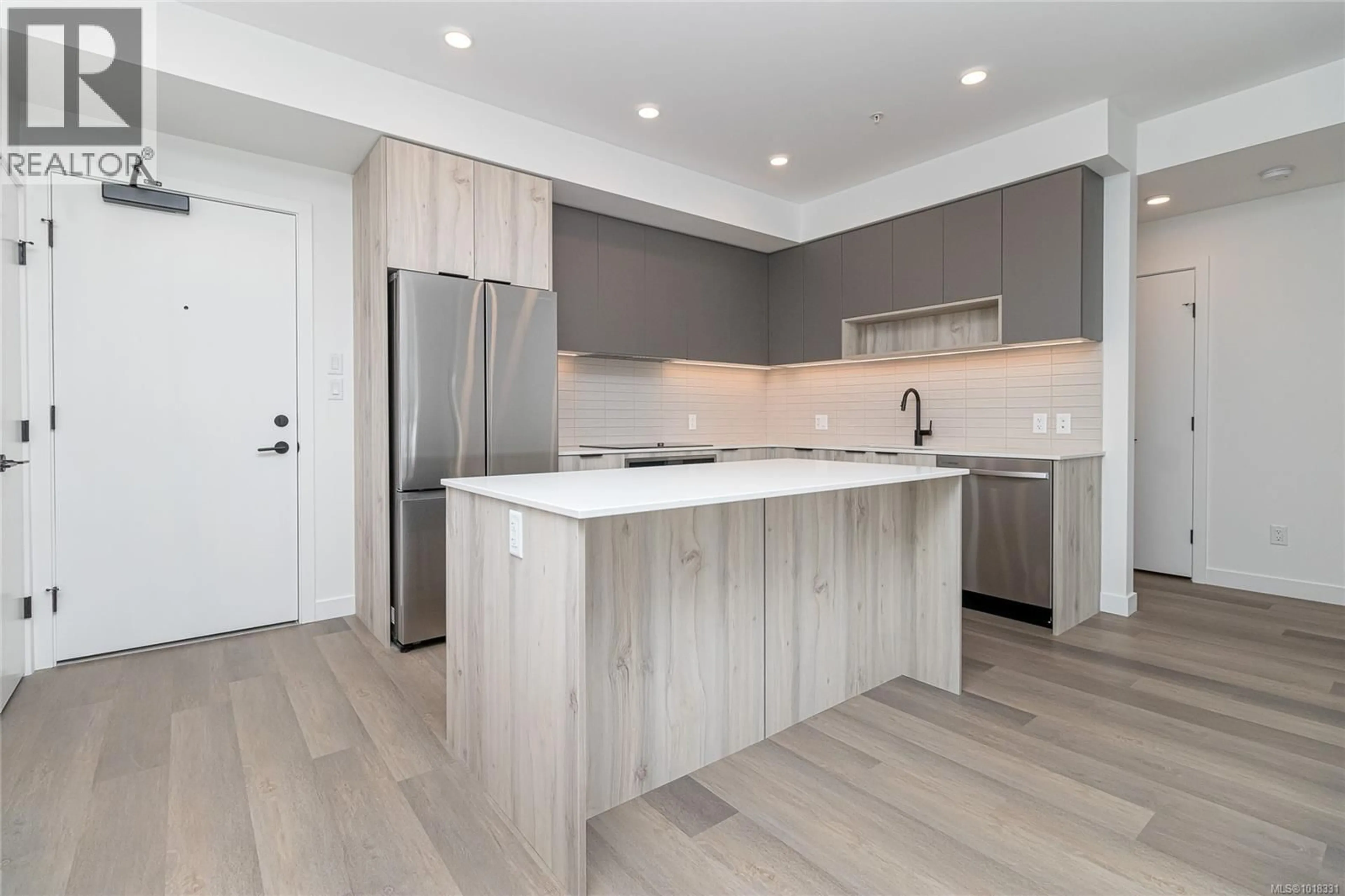 Open concept kitchen, wood/laminate floor for 312 - 3564B RYDER HESJEDAL WAY, Colwood British Columbia V9C0V4