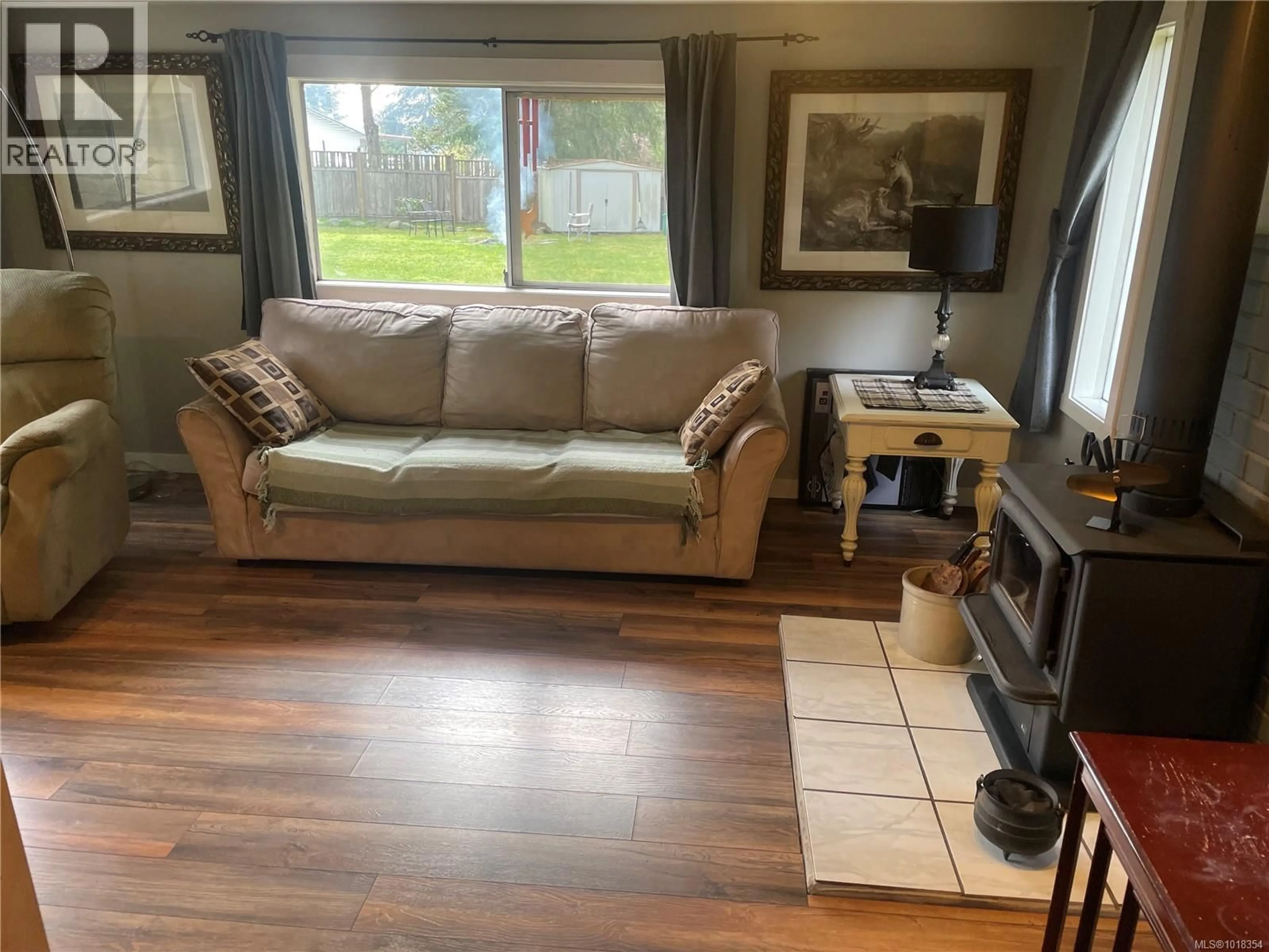 Living room with furniture, wood/laminate floor for 247 HUSON ROAD, Qualicum Beach British Columbia V9K2A2
