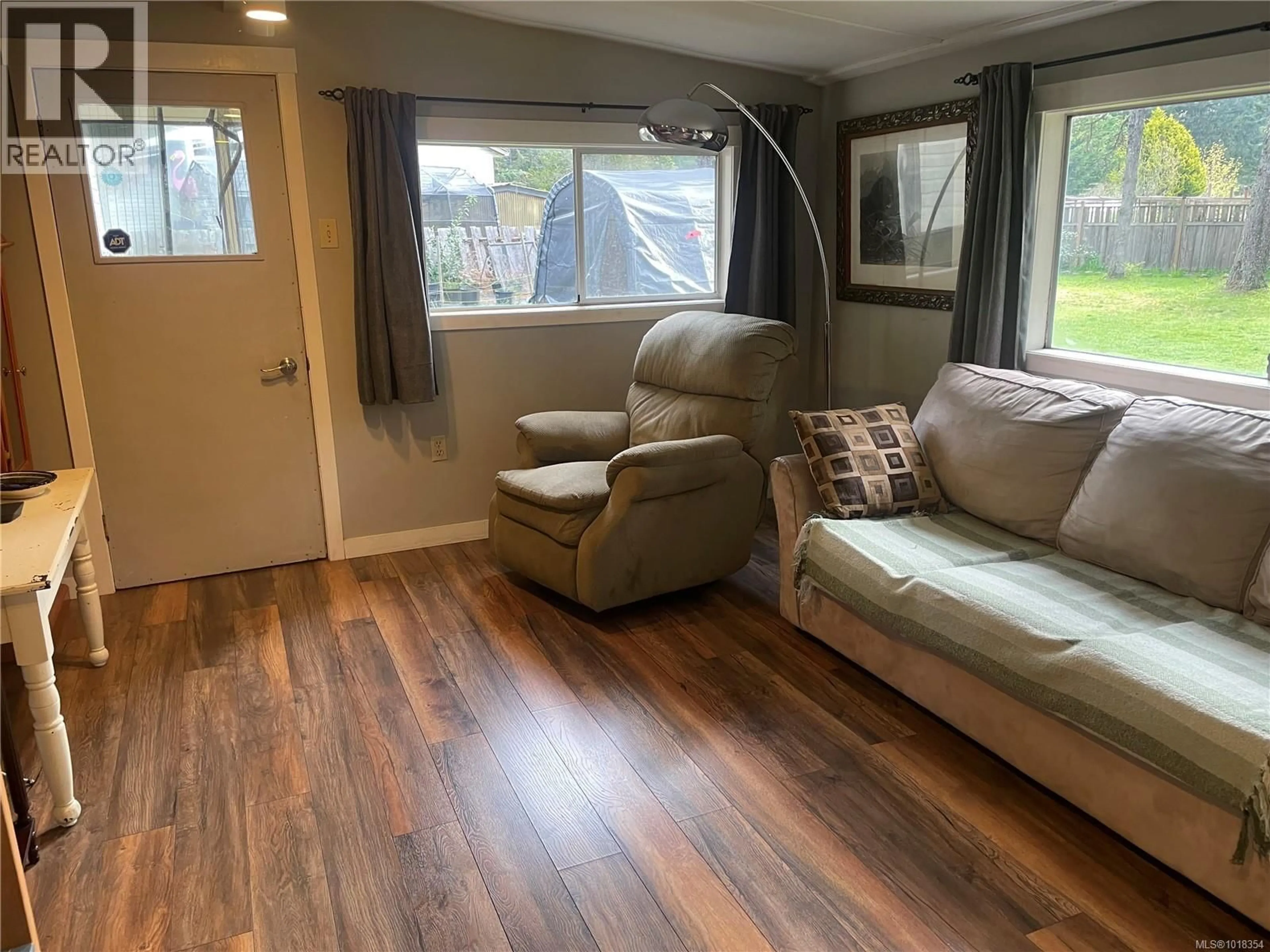 Living room with furniture, wood/laminate floor for 247 HUSON ROAD, Qualicum Beach British Columbia V9K2A2