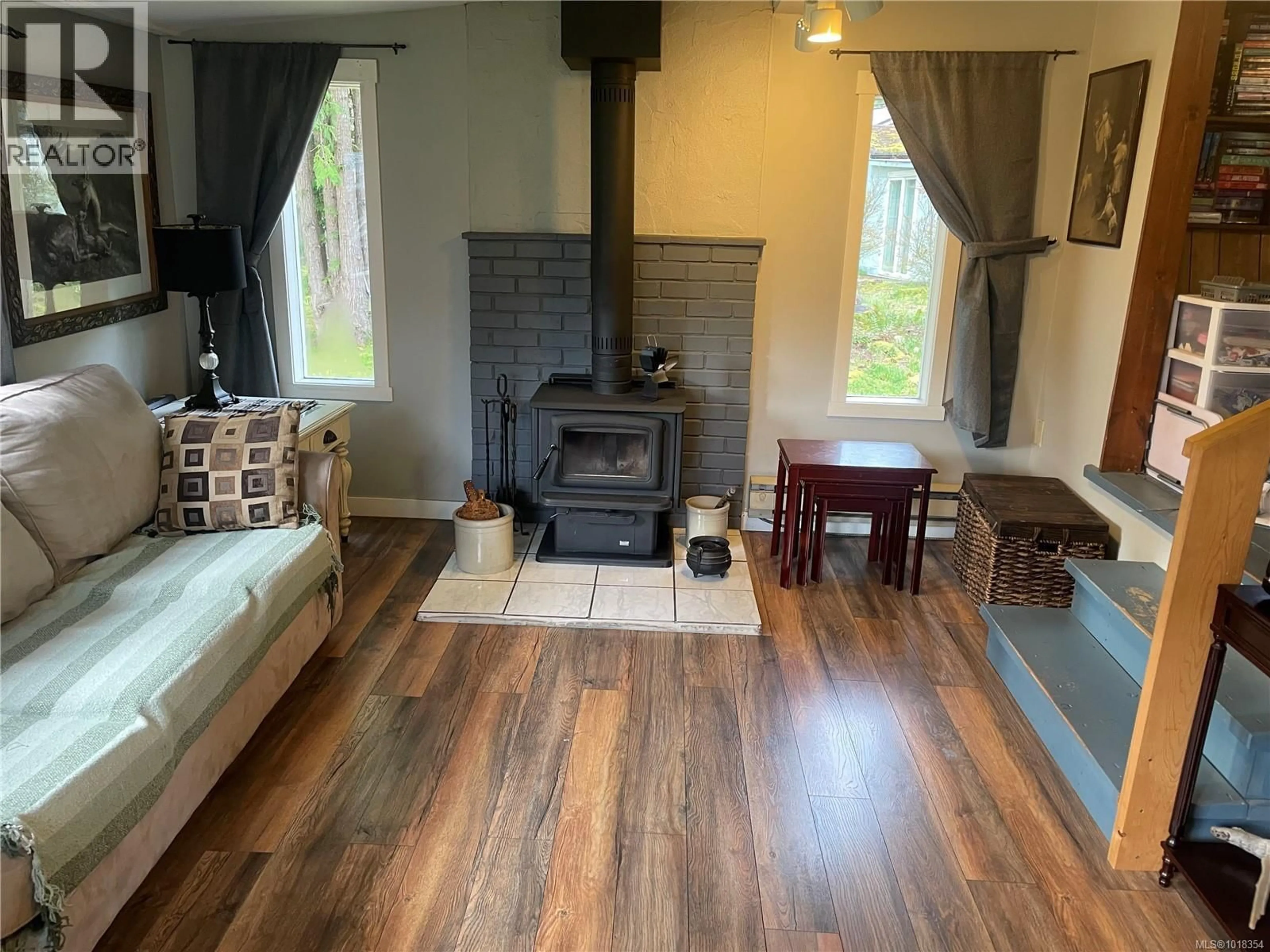 Living room with furniture, wood/laminate floor for 247 HUSON ROAD, Qualicum Beach British Columbia V9K2A2