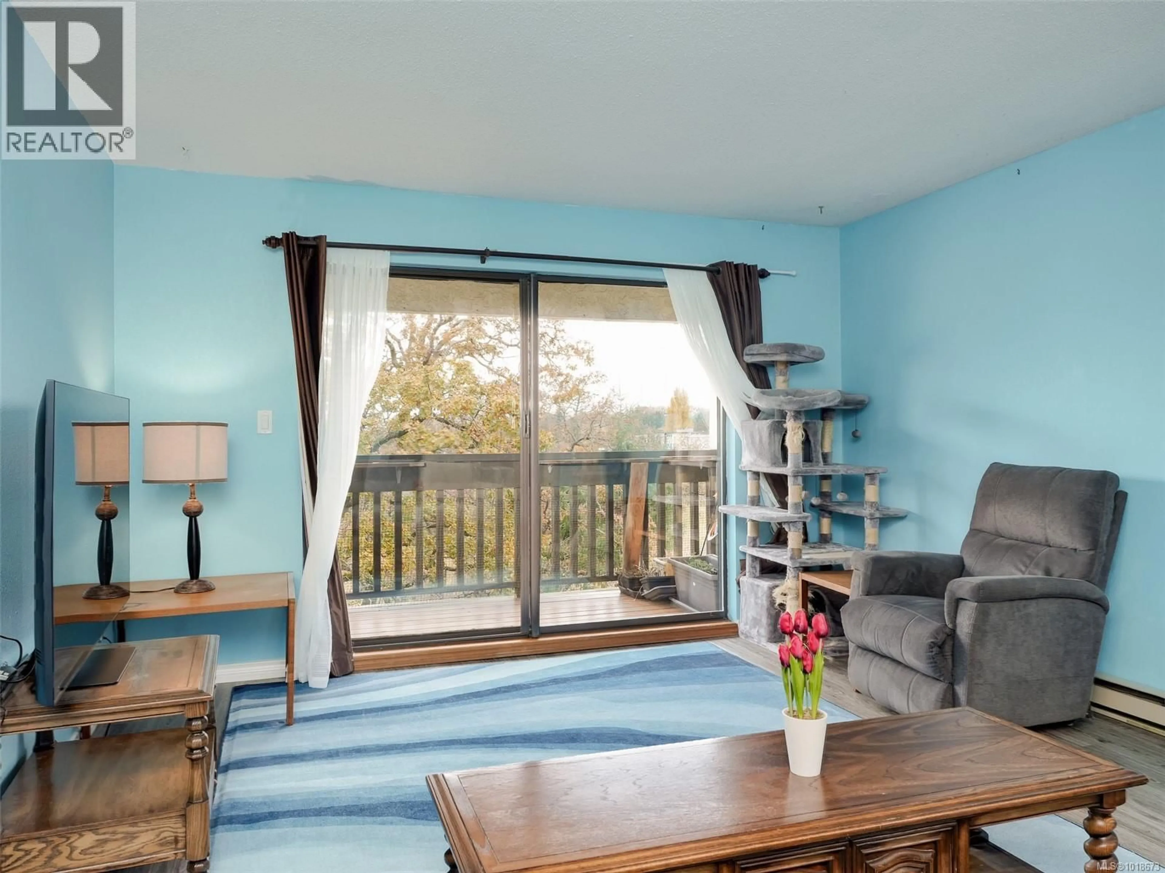 Living room with furniture, wood/laminate floor for 413 - 3277 GLASGOW AVENUE, Saanich British Columbia V8X1M3