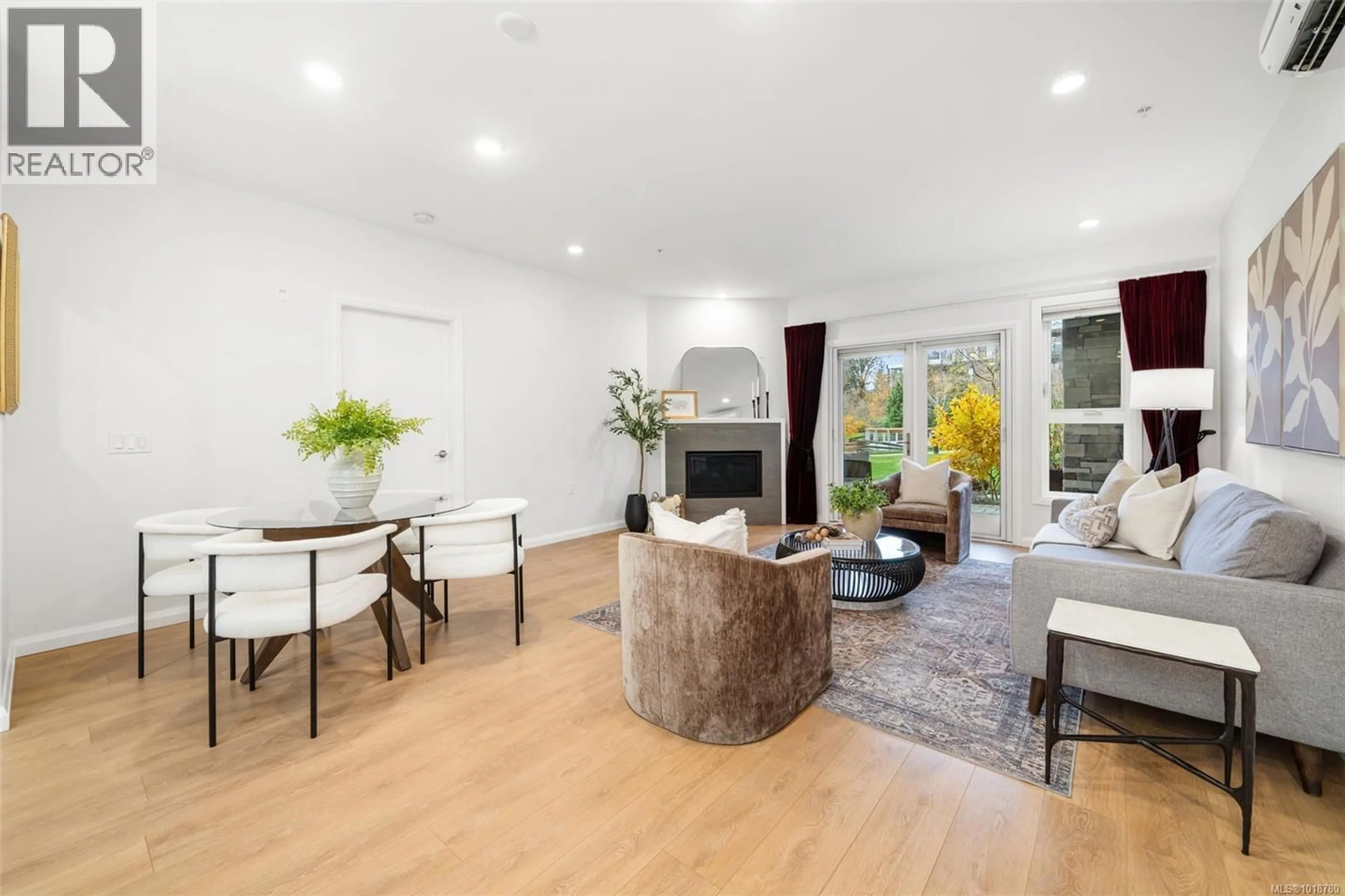 Living room with furniture, wood/laminate floor for 112 - 745 TRAVINO LANE, Saanich British Columbia V8Z0E5