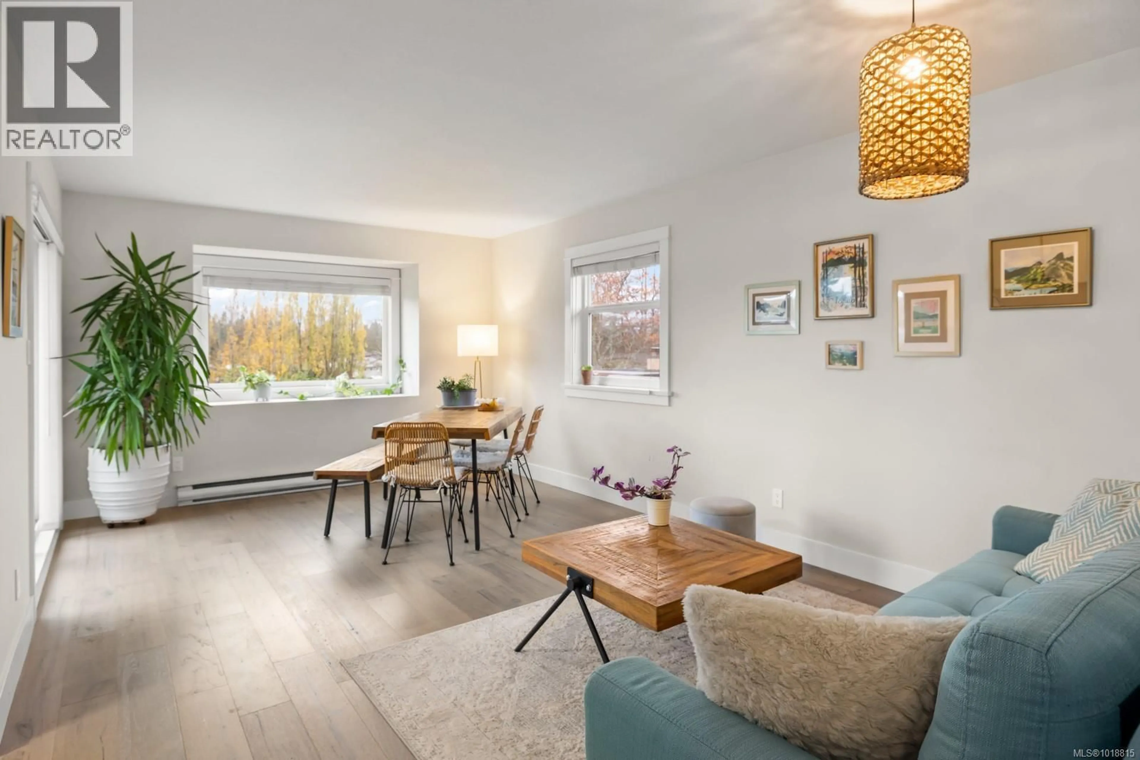 Living room with furniture, wood/laminate floor for 303 - 7070 WEST SAANICH ROAD, Central Saanich British Columbia V8M1P5