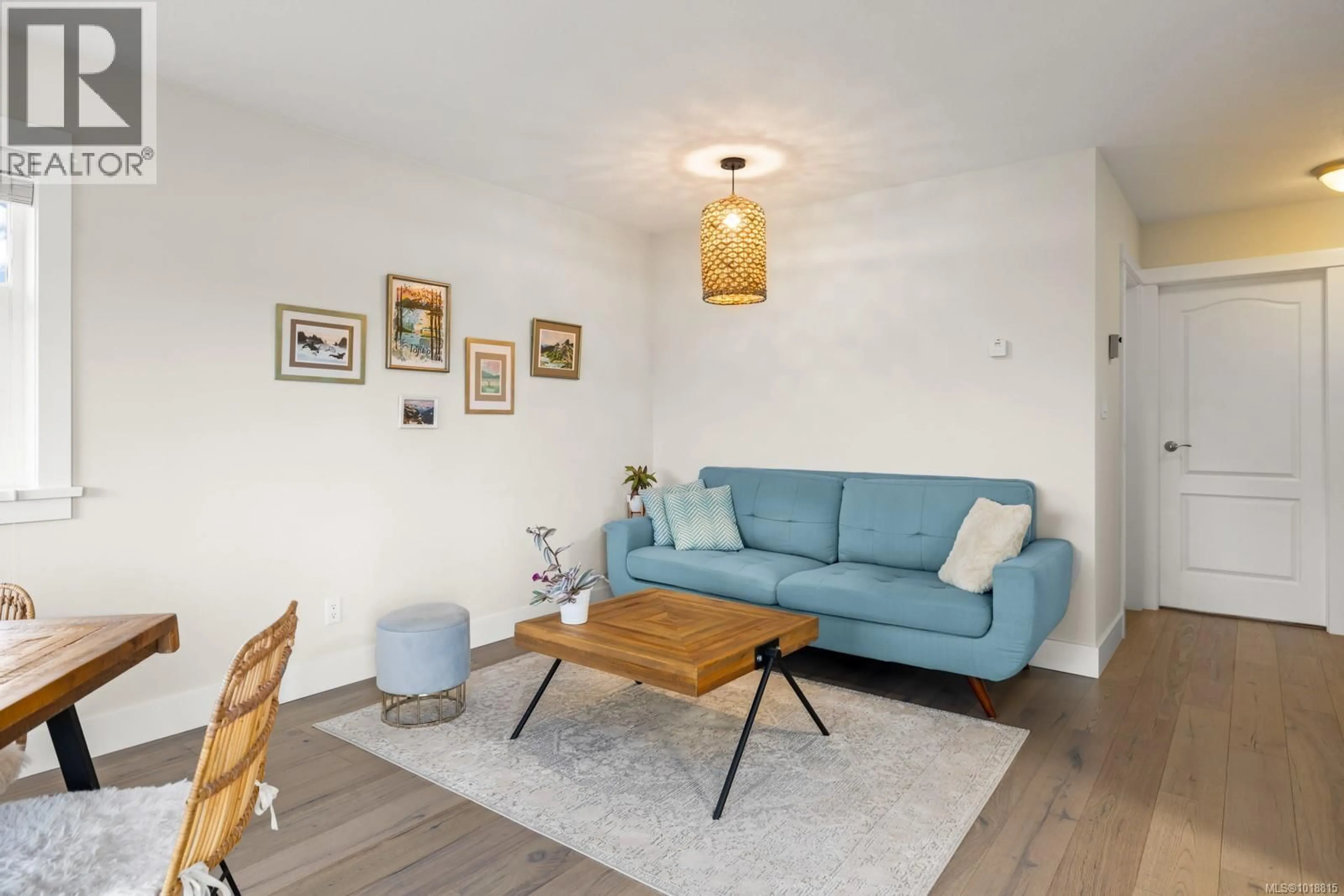 Living room with furniture, wood/laminate floor for 303 - 7070 WEST SAANICH ROAD, Central Saanich British Columbia V8M1P5