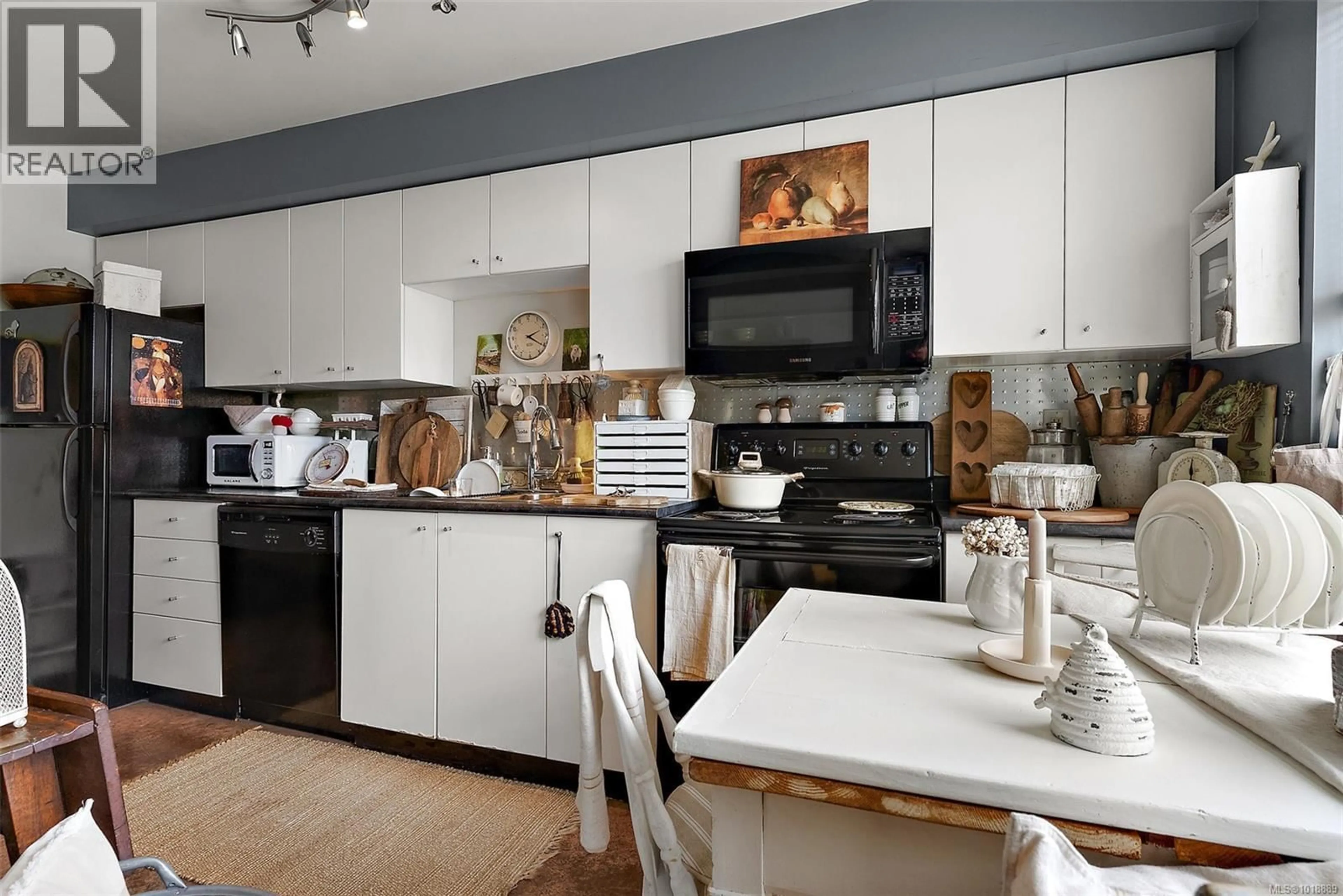 Open concept kitchen, wood/laminate floor for 306 - 932 JOHNSON STREET, Victoria British Columbia V8V3W3
