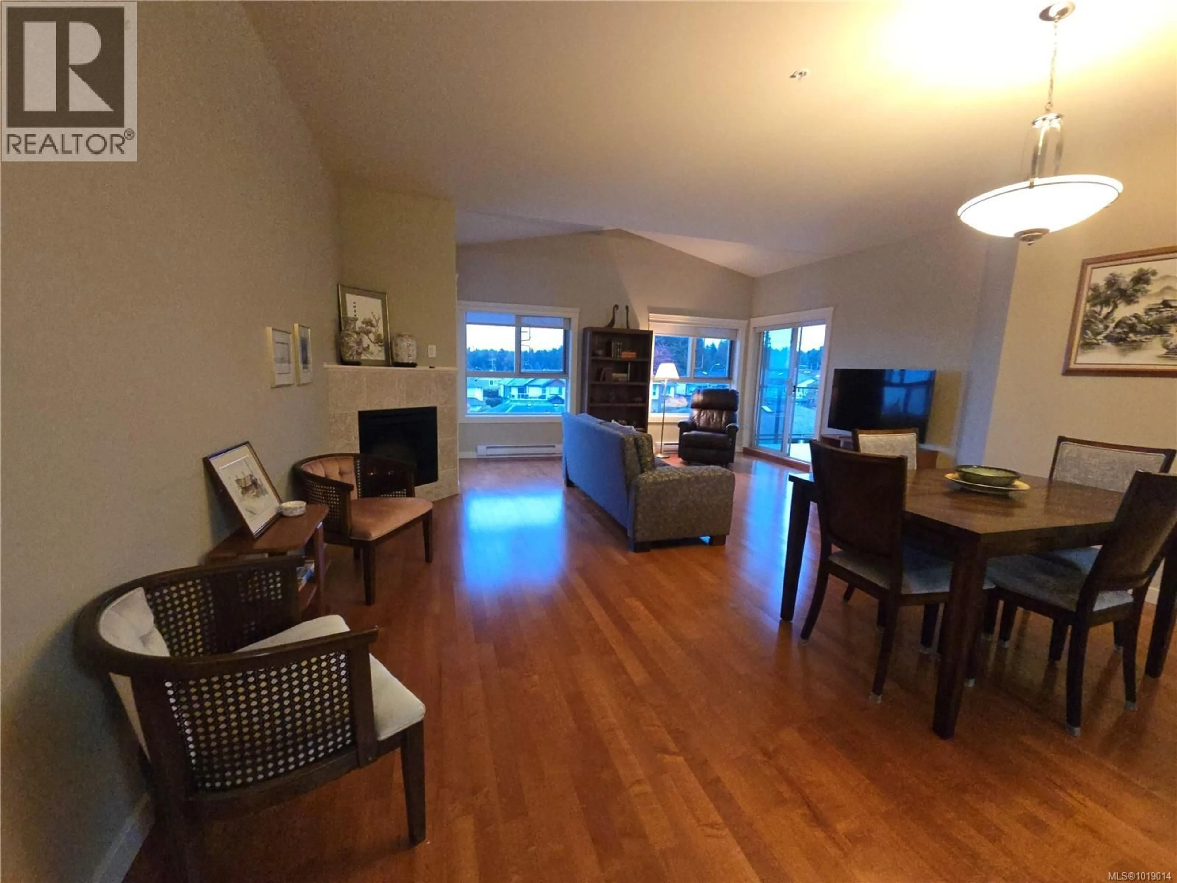 Living room with furniture, wood/laminate floor for 404 - 6728 DICKINSON ROAD, Nanaimo British Columbia V9V1T3